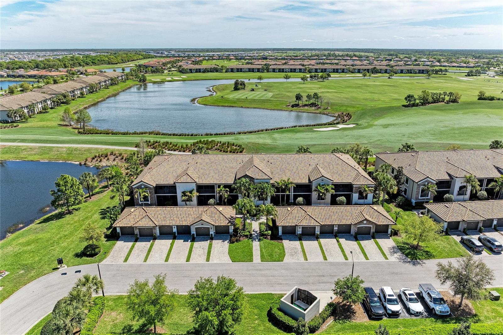 Experience front row seats overlooking the 18th hole of the desired Commander course during the LECOM Suncoast Classic on the Korn Ferry Tour. With unmatched views, this upscale turnkey property is in Lakewood National Golf Club, one of Lakewood Ranch’s premier gated golf communities. Beautiful golf, water and sunrise views, plus the convenience and easy access to world-class amenities makes this property outshine the others with two bedrooms, two baths, a spacious den and a one-car garage. Walking up to the front door, you are greeted with a large, enclosed patio and at the rear of the condominium is a spacious screened balcony overlooking what is traditionally the 9th hole of the Commander course (18 during tournament play). Inside the home lies a large kitchen with granite countertops. The main living area is spacious enough for separate dining and living room spaces with vaulted ceilings, crown molding and a dry bar. The home has tile flooring in the main areas, carpet in the bedrooms and new ceiling fans throughout. Also included is a detached garage with anti-slip painted floor coating and wall shelves. Golf cart is negotiable! Lakewood National Golf Club offers gated, maintenance-free living with extraordinary amenities that include 36 holes of Arnold Palmer-designed golf courses, a zero-entry heated pool with cascading waterfall and lap lanes, poolside tiki bar and café, fitness center with group exercise classes, on-site full-service spa, eight lighted Har-Tru tennis courts, bocce, pickleball and six additional satellite pools. Lakewood National Golf Club is home to the annual Korn Ferry tour with a 28,000-square-foot clubhouse that gives residents additional patio, private and fine dining, conference/event space, ladies and men’s locker room/lounge areas, and a large bar. There is no shortage of gathering places and the full-time lifestyle director means you’ll have a rich social life and more activities than you can dream of. Lakewood Ranch is ranked the No. 1 community in the U.S., which encompasses 50 square miles filled with dining, arts, entertainment, shopping, nature and recreation, and some of the most beautiful home choices for all ages and lifestyles. Additionally, the area maintains A-rated schools, easy access to Interstate 75, downtown Bradenton, Sarasota, Tampa, convenient to world-class beaches, spectacular shopping, great restaurants and entertainment. There’s no better location than Lakewood Ranch and no better community than Lakewood National Golf Club.