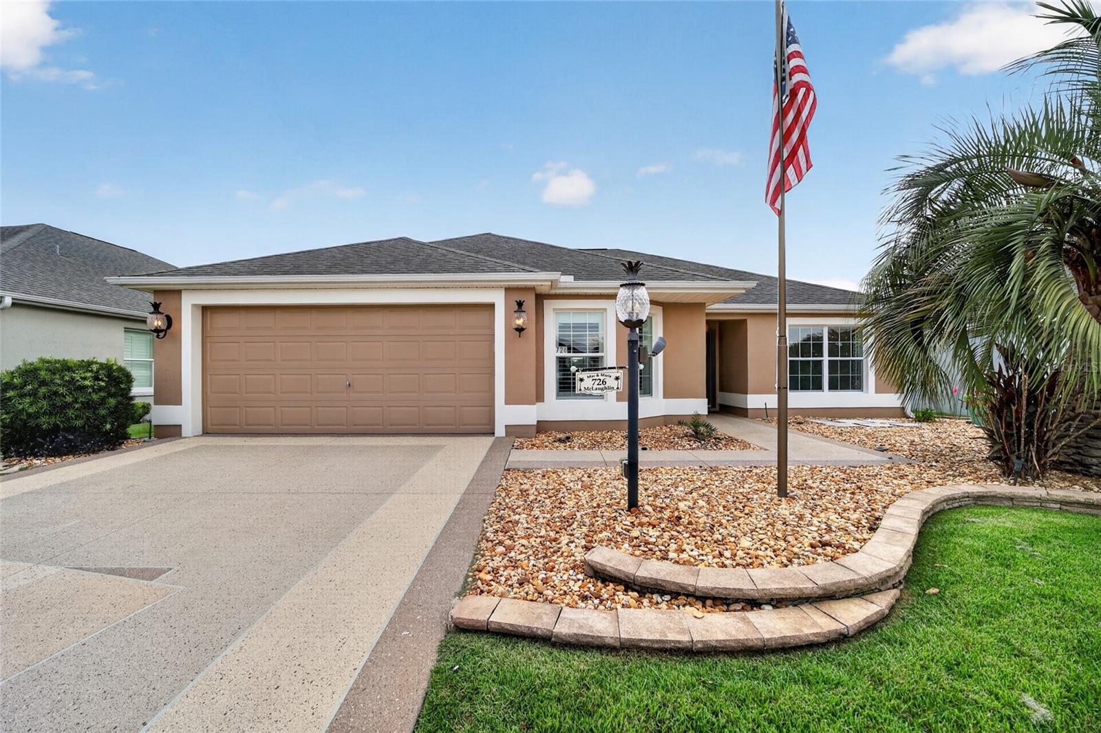Location...Location...Location...Welcome to this beautifully maintained Jasmine model in the highly desirable Village of Sanibel, conveniently located just minutes from Brownwood Paddock Square ~ This 3-bedroom, 2-bath home offers a perfect blend of comfort, style, and low-maintenance living. A beautifully designed decorative painted driveway and walkway create an impressive first impression while adding exceptional curb appeal and a custom designer touch. Attractive rock landscaping, freshly painted exterior (2025) a freshly painted interior (2026), block-and-stucco construction creates exceptional beauty from the moment you arrive. Inside, you’ll find vaulted ceilings, ceramic tile flooring, crown molding, plantation shutters, and ceiling fans throughout. The kitchen showcases granite countertops, a matching granite backsplash, convenient pull-out shelving in the lower cabinets, and new stainless steel appliances. The open floor plan creates an inviting space for both everyday living and entertaining. A pocket door provides added privacy for the guest wing, where both guest bedrooms feature built-in closets and share a guest bath with a cast-iron tub and shower combination. The spacious primary suite offers a walk-in closet, dual sinks, and a Roman shower. Additional features include an indoor laundry room with utility sink and linen closet, pull-down attic access for additional storage, a spacious 2-car garage offers additional room to accommodate a golf cart, and a convenient electrical outlet on the front lamp post for seasonal lighting and outdoor décor. Perfectly positioned to enjoy everything The Villages has to offer, this home is just a short golf cart ride to Brownwood Paddock Square, numerous championship and executive golf courses, recreation centers, swimming pools, pickleball and tennis courts, walking trails, shopping, dining, and nightly entertainment. Simply move in and begin enjoying The Villages lifestyle ~ This isn’t just your next home…it’s the beginning of your next adventure!