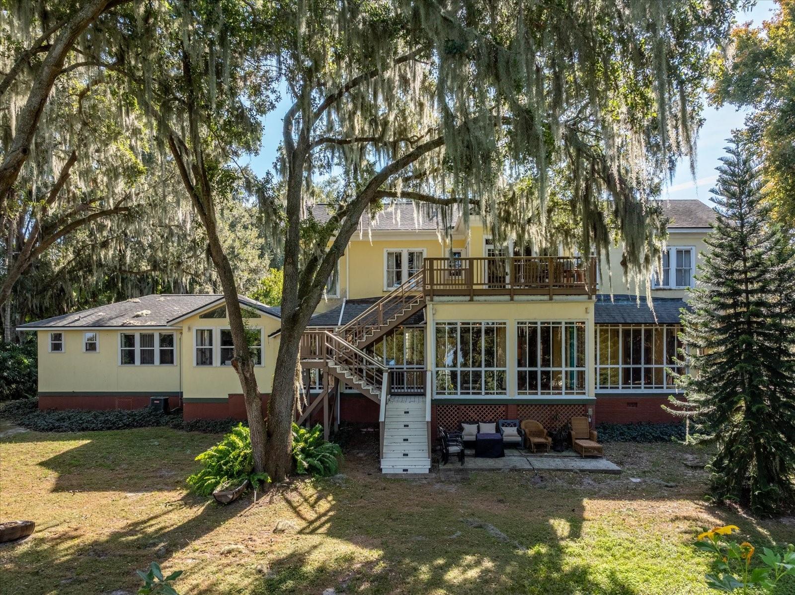 PRICE IMPROVEMENT! This exquisite gem has endless opportunities: a wellness center, wedding event venue, and Airbnb. Not looking to own a bed and breakfast? This would also make a fantastic stately residential home! This distinctive 19th-century Oakland Manor House sits on an .8-acre park-like setting in the charming town of Oakland. Carefully restored to preserve and enhance its original beauty with abundant woodworking, tall windows, 10’ ceilings, and elegant staircases. French doors connect the formal dining and living room to a grand Florida room with a hot tub and outdoor porch. A modern island kitchen features stainless steel appliances, 3 sinks, and a large pantry. A luxury updated master suite with a soaking tub is on the first floor, along with a private apartment with its own kitchen and separate entrance. The 2nd floor offers 4 themed bedroom suites, an upstairs living room/ lounge, and a porch with views of Lake Apopka.  All rooms have an internet-based locking system. 
The Oakland Manor House is conveniently located within 30 minutes of downtown Orlando, Disney, and Universal Studios. The West Orange Trail runs through the neighborhood. Easy biking distance to Winter Garden, which offers restaurants, farmer’s market, brewery, and music venues. The Oakland Nature Preserve is another nearby treasure. This is a unique opportunity to own a part of Oakland's history.  Bring your business ideas or reside in your own retreat. The sky is the limit!