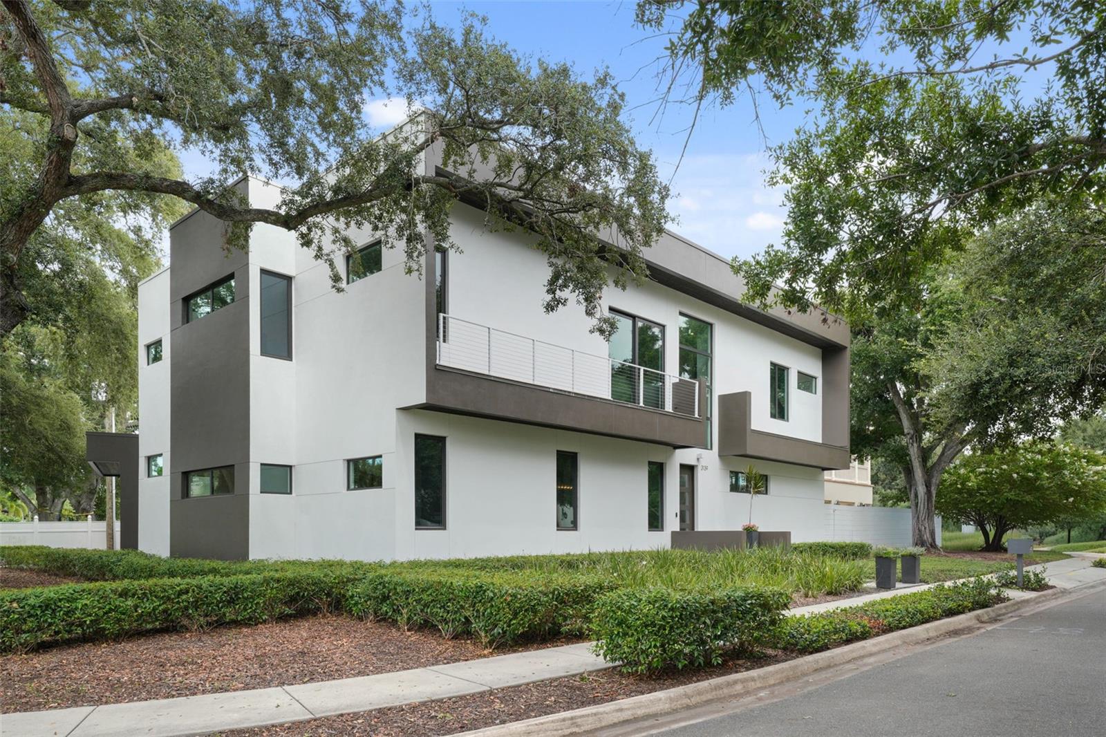 PRICE IMPROVEMENT!  This stunning residence stands 14 FEET ABOVE SEA LEVEL and just steps from the highly coveted Waverly Park Circle. It’s distinguished by its exceptional quality and modern architecture. Thanks to TWO STORY BLOCK construction, sand-smooth stucco, and impact-resistant windows and doors, the home is not only visually stunning but also meticulously crafted but virtually SOUND PROOF! Built as a personal residence by the architect and builder of custom homes, every detail has been artfully selected.  Designed with gatherings in mind, the home features a formal dining room with a custom table for fabulous dinner parties and a spacious family room perfect for fun holiday celebrations. When the festivities move outside, sliding open the wall of glass doors transforms the indoor living space into an outdoor sanctuary. Guests can enjoy the saltwater pool and spa, gather at the bar beside the fully equipped outdoor kitchen, or relax by the fire in the outdoor living area. Alfresco dining is easily accommodated with a dedicated table. Back inside, the kitchen will impress even the most discerning chef. Features include a Jenn air gas cooktop, dual built-in ovens, a Subzero refrigerator, and large island with extra storage and seating. The sleek, modern design of the custom cabinets and counters is easy to maintain, thanks to the walk-in working pantry with appliance counter and shelving. Other benefits to the home include a downstairs primary bedroom suite with two walk-in closets. The bathroom features a floating dual sink vanity and walk-in shower. A private study and powder bath complete the first floor. Upstairs, find a reading loft flush with an abundance of natural light. There are four additional secondary bedrooms and three bathrooms. Additionally, there is an expansive laundry and bonus room. Additional highlights include a temperature-controlled wine room with space for 333 bottles, a mudroom with plumbing for a future bath, an oversized two-car garage, and pre-wiring for a generator. Convenient to downtown Tampa, Bayshore, and A rated schools. Also, it's in an X FLOOD ZONE with NO FLOOD INSURANCE requirements. The only challenge with buying this remarkable home is deciding how best to enjoy all it has to offer! Schedule your showing today!