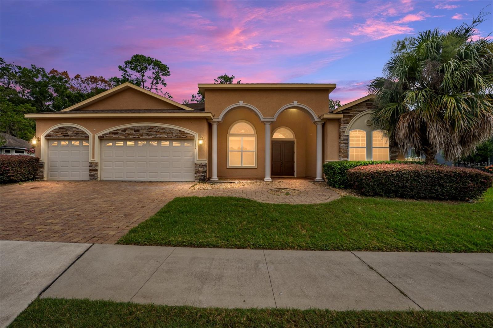 Virtually Staged. Welcome to this impressive 6-bedroom, 4-bathroom luxury home offering exceptional space, comfort, and thoughtful design. Featuring an attractive stucco exterior and a popular three-way split floor plan, this spacious residence provides the perfect blend of privacy and open-concept living.

Step inside through the grand entry and foyer to discover an inviting open floor plan enhanced by elegant tray ceilings and abundant living space. The expansive living area is centered around a cozy fireplace, creating a warm and welcoming setting for everyday living and entertaining.

At the heart of the home is the large chef's kitchen, beautifully appointed with granite countertops, maple cabinetry, generous prep and storage space, and a spacious eat-in dining area—perfect for gathering with family and friends.

The luxurious owner's suite offers a private retreat, while the owner's bath features beautiful travertine marble flooring and upscale finishes. With six bedrooms and four full bathrooms, this home provides exceptional flexibility for family, guests, a home office, fitness space, or multi-generational living.

Designed with energy efficiency in mind, the home features a tankless natural gas water heater, vinyl Low-E insulated windows, and additional energy-efficient features for enhanced comfort and convenience.

Located in the desirable Belmont community, residents enjoy an outstanding array of amenities, including front-yard maintenance, a resort-style community pool, party pavilion, dog park, playground, tennis courts, and basketball courts.

Spacious, beautifully appointed, and designed for comfortable Florida living, this exceptional home offers the space you've been looking for along with the convenience of a vibrant, amenity-rich community. Schedule your private showing today and experience this remarkable home!