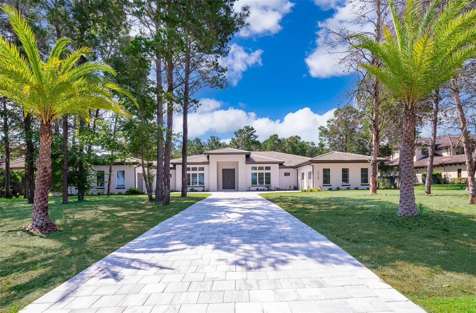 This stunning, brand new, single story home offers 4 bedrooms and 5 1/2 bathrooms. As a former model home, it was custom-designed by Primo Homes. The home offers 4,861 heated square feet and over 7,500 total square feet. This spacious home has an open floor plan with a private home office near the entrance. The kitchen has a large island with custom cabinetry and Thermador appliances. The spacious laundry room has new washer and dryer and comes equipped with a pet shower station. The flooring throughout the home consists of oversized tiles with wood floors in the bedrooms. The master bedroom has two large, walk-in closets and double-doors leading to the lanai. The master bathroom has dual shower heads and a self-standing tub. The oversized outdoor covered entertainment area has retractable screens and a fully-equipped outdoor kitchen with custom cabinetry and a large island. This area also has two bathrooms, a shower and a custom-built sauna. The resort-style pool and spa overlooks the one-acre plus lot. Enjoy the amenities Bella Collina has to offer including two restaurants with outdoor patios, 5-star spa, championship golf course, 5 tennis courts, basketball court, 3 pickle ball courts, fitness center with complimentary fitness classes for residents, a pool complex with bar and cabanas and year-round culinary and social events.