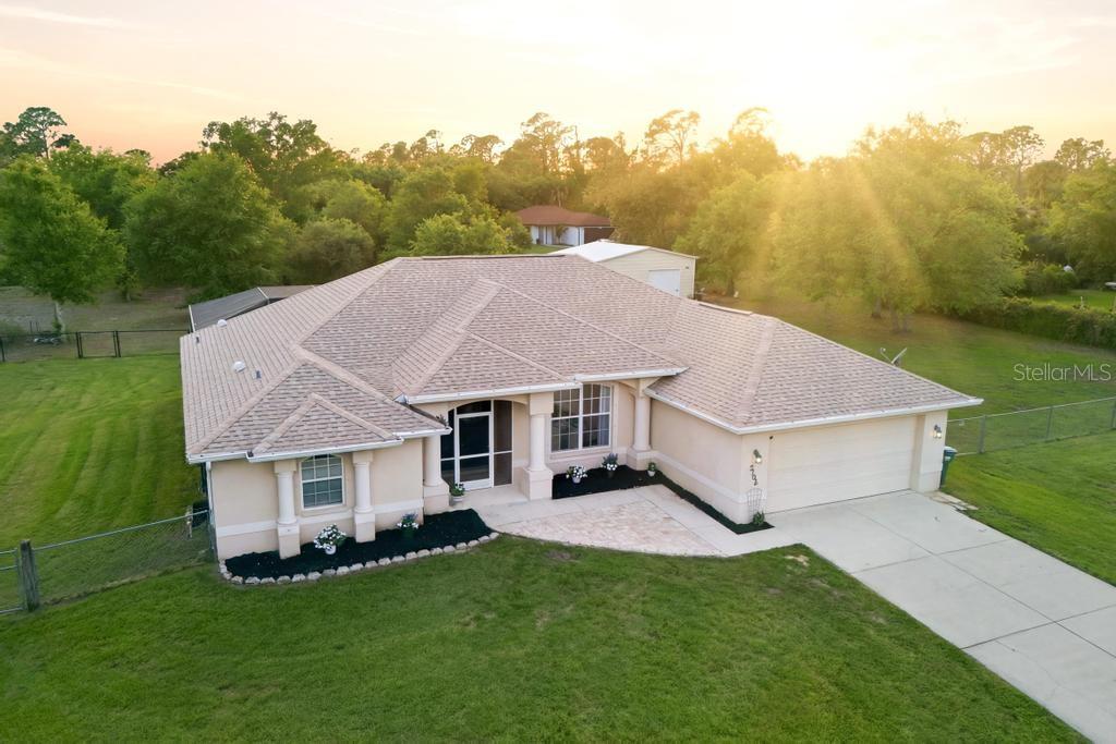 A rare find in coastal Florida—where space, privacy, and freedom come together on fenced acreage with no deed restrictions or HOA fees. This 4 bedroom, 2.5 bathroom pool home offers the opportunity to spread out, store your toys, build, garden, or simply enjoy quiet, unrestricted living.

An extended screened porch leads into a beautiful foyer and great room with vaulted ceilings and a view of the nearly new pool. The split floorplan affords privacy and flexibility, with the master suite enjoying walk-in closets and an ensuite bathroom with a soaker tub and tiled shower. Bedrooms 2, 3 and 4 are split on the other side of the home with a full bathroom and access to the lanai.  

The home has been thoughtfully updated over time, including a new roof (2023) with transferable warranty, HVAC (2016) with air purifier (2020), water softener system (2019), submersible well pump (2012), newer dishwasher (2019) refrigerator (2025), garbage disposal (2021) and water heater (2024), giving you peace of mind where it matters most. Septic tank was pumped in 2025.

The gorgeous screened 2023 heated saltwater pool with design features like a large sunshelf and fountain, enjoys a spacious entertainment deck, tiki bar area, vibe lighting and a half bathroom.  As if that wasn't enough already, this property also comes with a recently built detached shop with mini split air conditioning and two garage doors with openers, ideal for vehicles, hobbies, storage, or workspace. The land is fully fenced with cross fencing and multiple gates, making it functional for animals, equipment, etc.

Surrounded by mature oaks and dotted with young mango, avocado, olive, pomegranate, mulberry, and dragon fruit trees, this property has a laid-back, Old Florida feel while still offering usable, cleared space and easy access to shopping, dining, and entertainment. 

North Port is located at an ideal juncture giving you nearby beach options north or south in Englewood, Fort Myers, Sarasota, Venice and Nokomis. You'll also have the option to enjoy the amenities of both Sarasota County and Charlotte County, like spring baseball training, live music, art, music and food festivals, boating, and so much more.

REALTORS, PLEASE READ PRIVATE REMARKS IN FULL.