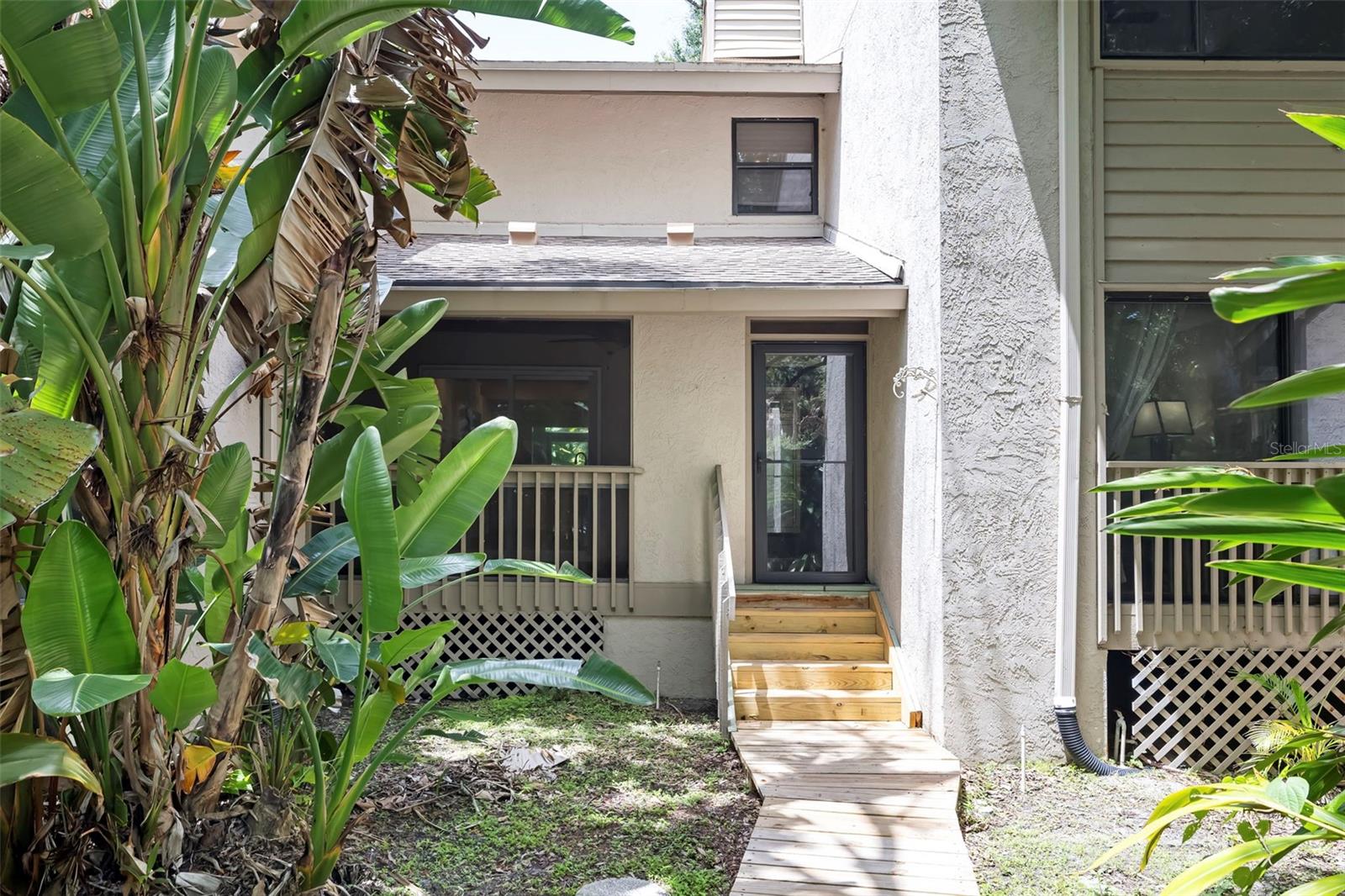 Beautifully updated 3-bedroom + loft, 3 full bath townhome located in the desirable Arboreal community in the heart of Midtown Sarasota. Thoughtfully redesigned from top to bottom, this home showcases exceptional craftsmanship and custom finishes throughout.

The spacious living area features soaring cathedral ceilings enhanced with skylights, exposed beam accents, custom wood ceiling details, a striking brick accent wall surrounding the wood-burning fireplace, and handcrafted red oak and aluminum stair railings imported from Sweden. Tile flooring extends throughout the home, complemented by updated lighting, glass interior doors, and a fresh, modern aesthetic.

The kitchen blends style and functionality with solid wood cabinetry featuring soft-close drawers, Silverstone "Brooklyn" countertops, a custom tile backsplash, stainless steel appliances including an LG induction cooktop and oven, a breakfast bar, and a Bosch washer and dryer.

The primary suite offers vaulted ceilings and an expanded layout, creating a comfortable retreat. The ensuite bathroom includes a spacious walk-in shower with both rain and handheld showerheads, a folding bench, bidet, dual sinks, a solid wood vanity topped with marble, and a lighted smart mirror with an integrated makeup mirror.

Two additional bathrooms have also been tastefully updated. One features a granite-topped vanity, jetted soaking tub with a dedicated water heater, and a custom glass shower enclosure, while the third bath has also received stylish upgrades.

Arboreal is a peaceful, pet-friendly community of just 30 residences surrounded by mature oak trees and tropical landscaping. Residents enjoy access to a clubhouse with an expansive screened community pool, and a tennis court, all while being conveniently located near Sarasota's shopping, dining, parks, and cultural attractions.

This is a wonderful opportunity to own a thoughtfully updated home in one of Sarasota's most charming communities. Schedule your private showing today.