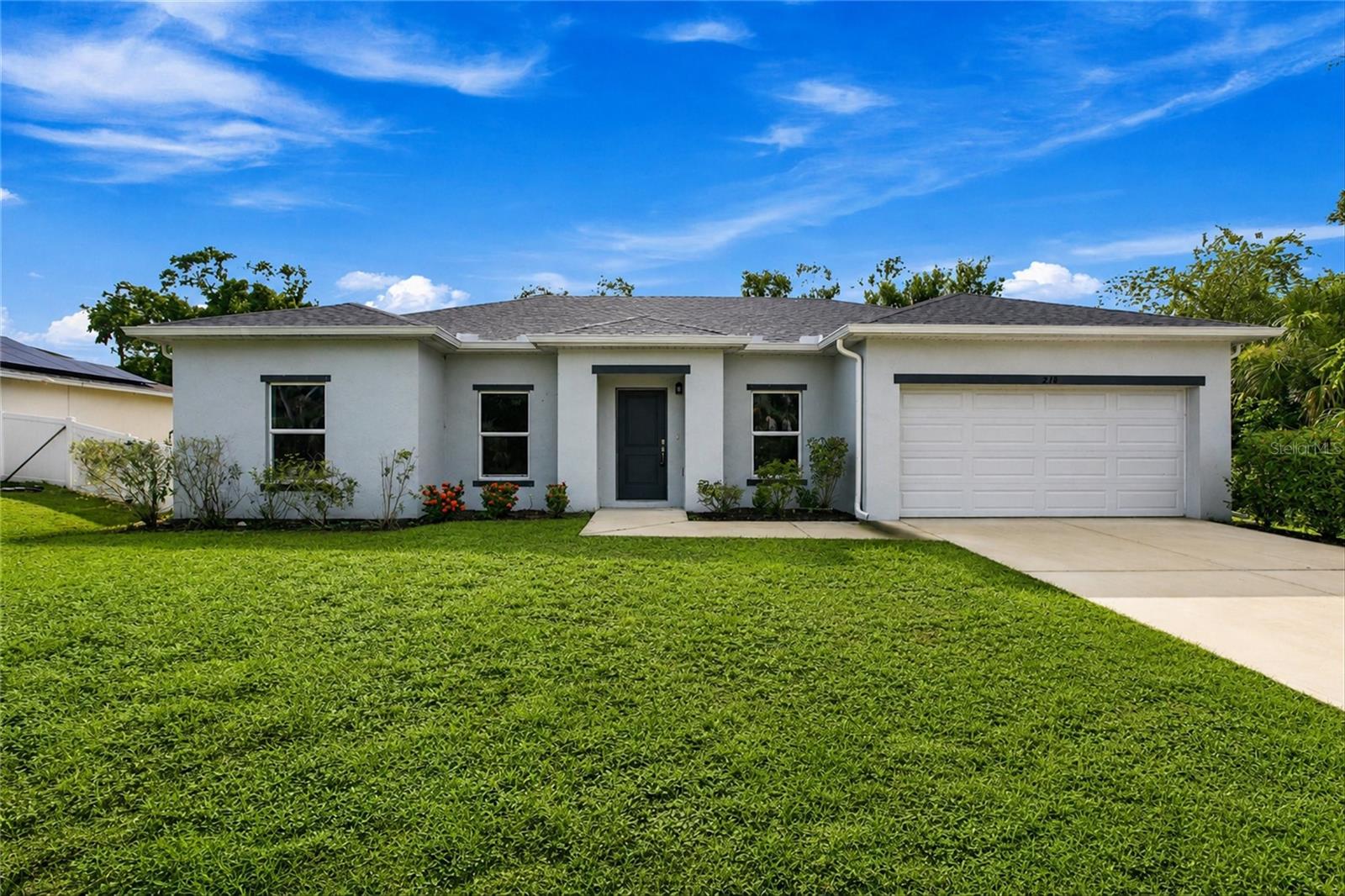 Virtually Staged. Welcome to this beautifully designed 4-bedroom, 2-bathroom home with a 2-car garage, built in 2022 and offering 1,670 square feet of thoughtfully crafted living space. Nestled in a peaceful Port Charlotte neighborhood, this newer construction home seamlessly blends modern comfort, functionality, and privacy. From the moment you arrive, you'll appreciate the inviting curb appeal, clean architectural lines, and spacious driveway. Step inside to discover a bright, open floor plan designed to complement today's lifestyle, with comfortable living spaces ideal for both everyday living and entertaining. At the heart of the home is the open-concept kitchen, dining, and living area. The stylish kitchen features granite countertops, stainless steel appliances, abundant white cabinetry, a generous pantry, and a large center island with bar seating. The seamless flow into the dining and living spaces creates an inviting atmosphere, while recessed lighting, neutral finishes, and expansive sliding glass doors fill the home with natural light and enhance its bright, airy feel. Designed with privacy in mind, the split-bedroom floor plan places the spacious primary suite apart from the secondary bedrooms. The owner's retreat offers a large walk-in closet and a private en-suite bathroom complete with dual vanities and a tub/shower combination, creating a comfortable space to relax and unwind. On the opposite side of the home, three well-sized guest bedrooms feature plush carpeting and ample closet space. A full guest bathroom serves these rooms, providing a functional layout for family members, guests, or a home office setup. Situated on a generously sized lot, the property backs to a beautiful, wooded area, offering a peaceful and private backdrop with no immediate rear neighbors. The expansive backyard provides endless possibilities, with plenty of room for outdoor entertaining, gardening, pets, or even the addition of a future pool. Additional features include an interior laundry room conveniently located just inside the attached two-car garage, offering practical storage solutions and everyday convenience. Built in 2022, this move-in-ready home delivers the peace of mind, energy efficiency, and modern features that come with newer construction. Conveniently located near shopping, dining, parks, schools, and all that Port Charlotte has to offer, this exceptional property presents an outstanding opportunity to embrace the Florida lifestyle.
**PLEASE ENJOY THE 3D INTERACTIVE VIRTUAL TOUR ASSOCIATED WITH THIS LISTING**