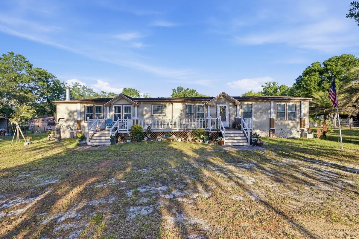 Discover the possibilities with this unique 3.66-acre property offering privacy, versatility, and room to grow. The front portion of the property features a beautifully cleared and open homesite, perfect for enjoying wide-open spaces, while the wooded rear acreage includes trails ideal for exploring, riding, recreation, or simply enjoying nature right in your own backyard.

The property includes two mobile homes, creating an excellent opportunity for multi-generational living, guest accommodations, or potential rental income. The primary residence is complemented by a spacious screened porch constructed with durable 2x6 framing and features energy-efficient double-pane windows. The second home could benefit from some updating and TLC but offers tremendous potential as an in-law residence, guest house, or income-producing rental.

Additional improvements include four covered carports providing ample space for vehicles, boats, RVs, or equipment, two storage sheds, an above-ground pool, two separate septic systems, and a private well. With plenty of room for toys, hobbies, animals, or future improvements, this property offers the freedom of country living while maintaining endless possibilities for personal use or investment.

Whether you're seeking space to spread out, a property for extended family, or an opportunity to generate additional income, this versatile acreage is packed with potential.