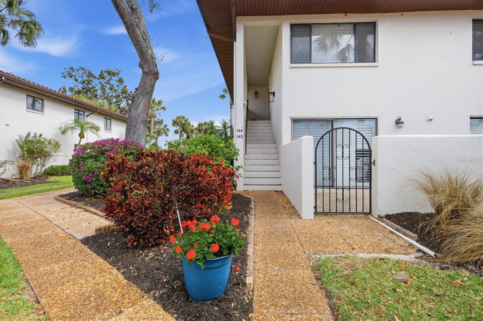 You will not find a nicer 3 BEDROOM UPSTAIRS END UNIT than this beauty!  Enjoy the awesome setting overlooking IMG Golf hole #2 green, surrounded by trees, landscaping and water.  The kitchen offers stone counters, stainless steel appliances, breakfast bar, and open to the family room.  Bathroom 2 is convenient for guests and services both secondary bedrooms, with updated vanity, flood and shower tile.  Laminate flooring thru master bedroom, family room and dining space, while ceramic tile covers the sunroom overlooking the back and the two bathrooms.  Master bedroom has a walk-in closet, bathroom with walk-in shower, double vanity and large linen closet.  Designated carport spot as well as guest parking, owners also enjoy a community pool, and condo dues that include ground maint., cable and internet, water and trash, etc.  Located close proximity to IMG Academy, IMG Golf, Detwiler Farm Market, Publix, Target.  Short drive to Bradenton beaches and downtown Sarasota.