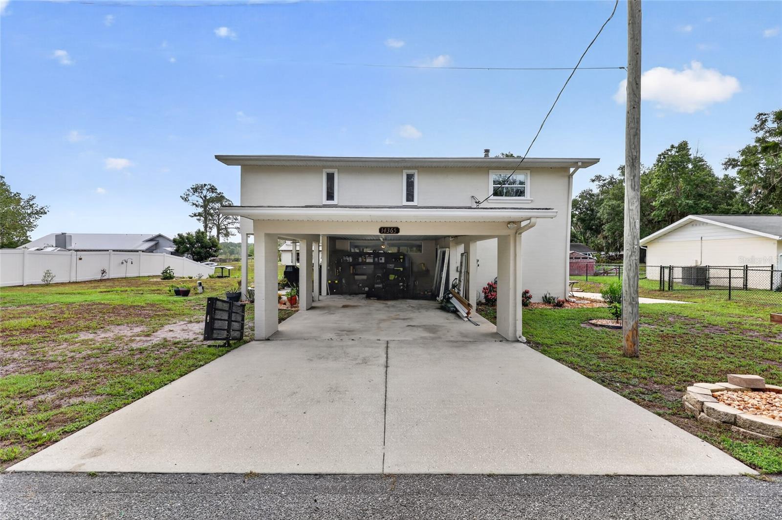 Welcome to your waterfront retreat at 14365 SE 107th Ave in Summerfield! Nestled along a freshwater canal with access to the beautiful Lake Weir system, this unique two-story home offers the perfect blend of Florida living, flexibility, and income potential.

Enjoy beautiful water views and the convenience of your very own private boat ramp—making it easy to launch your boat, kayak, or enjoy a day of fishing and exploring the lake.

The home features two A/C units for added comfort and efficiency, along with a water softener and water purification system. The downstairs offers a private one-bedroom, one-bath suite complete with a full kitchen and living space, making it ideal for an in-law suite, guest quarters, or potential rental opportunity.

With spacious living areas, waterfront access, and a versatile floor plan, this property is perfect for full-time living, a vacation getaway, or a multi-generational household. Bring your boat and start enjoying the waterfront Florida lifestyle!