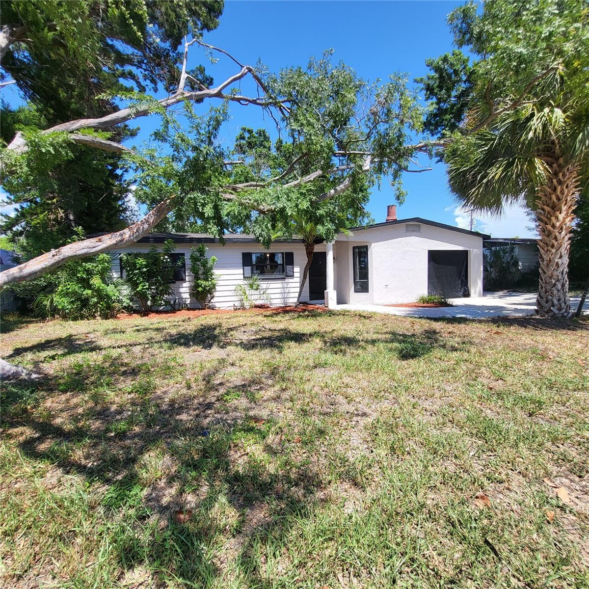 GOT TOYS?  No HOA, a large DOUBLE DRIVEWAY + an EXTRA LONG PARKING PAD means you have the freedom to PARK YOUR BOAT, RV, trailer, work truck and more without any expensive storage fees!  You're sure to love this well maintained 3/2 home with NEW ROOF & EXTERIOR PAINT (2024) that is situated in the heart of Town ‘n’ Country, one of Tampa’s most convenient and desirable areas.  Ideally located just minutes from top-rated restaurants, major hospitals, numerous sports venues, the Veterans Expressway, Downtown Tampa, the Tampa Airport and only a 30-40 minute drive to theme parks or the beautiful beaches of the Gulf Coast and Tampa Bay.  With just over 1,700 sq ft of living space, this is a GREAT OPPORTUNITY for someone looking for room to spread out and the ability to make it their own. This spacious home includes a main living/dining area, a separate dining room, an additional flex space/family room that was once used as a Primary bedroom as well as a small room without a closet that could be used as a Nursery or OFFICE.  The kitchen offers lots of cabinets and counterspace and is also conveniently accessible through the side door to the parking pad.  There is also an ENCLOSED CARPORT that can easily become a private garage by adding a garage door.  A SEPARATE UTILITY ROOM houses the Washer & Dryer, a NEW HOT WATER HEATER (2026) and has extra space for your storage needs.  Currently, the front LIVING ROOM with FIREPLACE is used as a recreational room with pool table (which can be left if desired) and also offers room for a table & chairs which is ideal as it is located just off the kitchen.  A formal dining room/bar area is centrally located and offers additional seating plus has access to the OVERSIZED COVERED & SCREENED BACK PATIO.  The SPACIOUS FAMILY ROOM at the back of the house has a small closet, sliders to the back patio and a pocket door to the dining area as well as a door into the 3rd bedroom allowing residents to pass through this home with ease.  Down the main hall to the 3 bedrooms there is also an UPDATED FULL BATH with walk-in shower as well as a small room without a closet or window that is currently used as a guest room.  The secondary bath is original and is conveniently located in the center of the house behind the dining area & kitchen and also has a walk-in shower and built-in storage.  A FULLY FENCED BACKYARD with MATURE TREES offers SHADE & PRIVACY and there are no direct backyard neighbors as this home backs to the end of Pepper Mound Creek.  But not to worry, there has been NO FLOODING here even during the major hurricanes of 2024.  Seller does have an assumable flood insurance policy for the next owner of this great property so be sure to inquire for more details.  For added peace of mind, the seller has obtained a PASSING 4 POINT INSPECTION dated June 2026.  Sold AS-IS for seller convenience and priced accordingly!  Don't miss this opportunity-call today before someone else beats you to it!