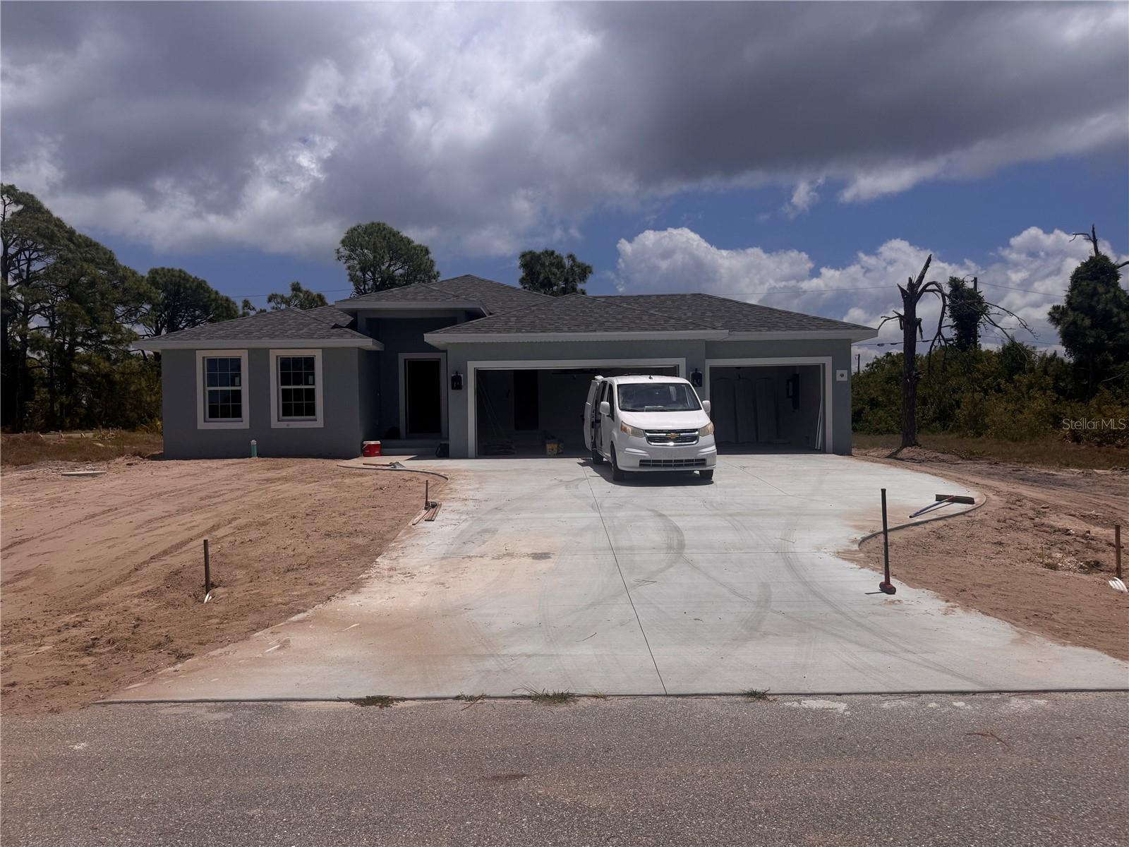 Under Construction. X FLOOD ZONE !!!! Our SGC 1 Model features an open floor plan from the minute you walk in the door. This home as 1663 sq foot of Living Space, 3 bedrooms, 2 baths and 3 Car Garage. The open kitchen is perfect for entertaining, includes a spacious island, breakfast/dining area, and doors leading to the lanai to enjoy your morning coffee. The master bedroom includes a walk-in closet, Tiled shower, and Dual sink vanity. The 2 Guest bedrooms are located on opposite side of Master making it a split floor plan. Guest bathroom has a tiled shower/tub combo. The living room features cathedral ceilings. The home features plank tile throughout, granite countertops in the kitchen and bathrooms, recessed lighting, ceiling fans in every room, and Stainless Steel Appliances. The home comes with hurricane/storm shutters. COME VIEW THIS BEAUTIFUL HOME or CALL TODAY FOR AN UPDATED LIST OF OUR BUILDS! PLEASE NOTE - the pictures for this listing are representative of the subject home being constructed. Interior and exterior paint colors, shingle colors, tray ceilings, fans, lights, manufacturer of appliances, interior/cabinet door style, and landscaping are subject to change.