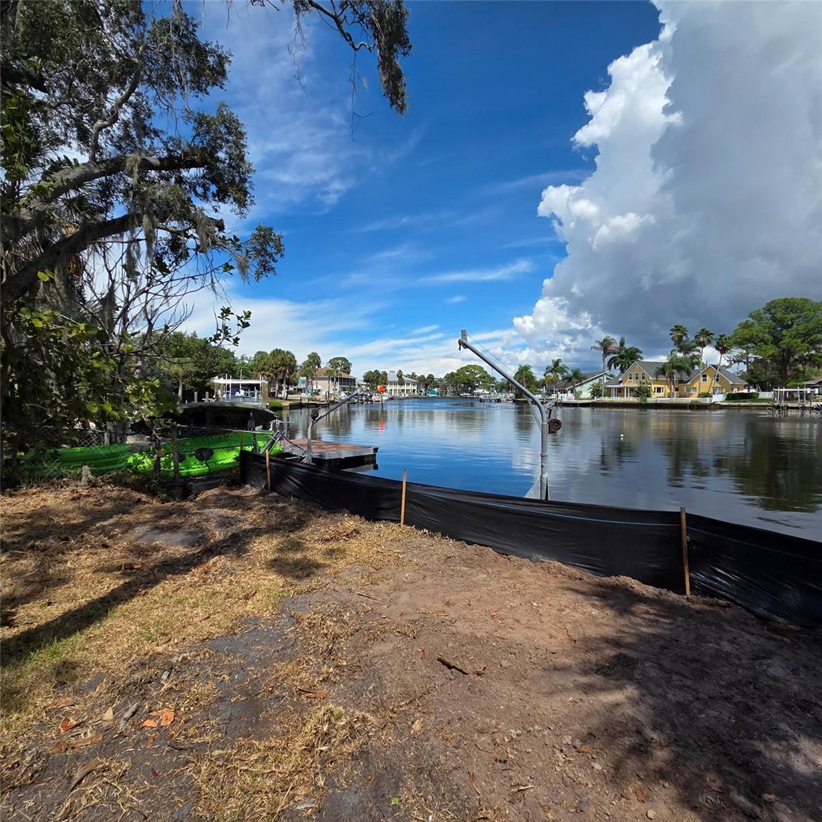 Riverfront lot for sale in New Port Richey — .31?± acres zoned R1. Located on a dramatic bend of the Pithlachascotee River with direct channel access to the Gulf of Mexico. City water and sewer available. Lot purchase only or build-to-suit option available. Ideal location for a custom waterfront home with stunning views and boating access.