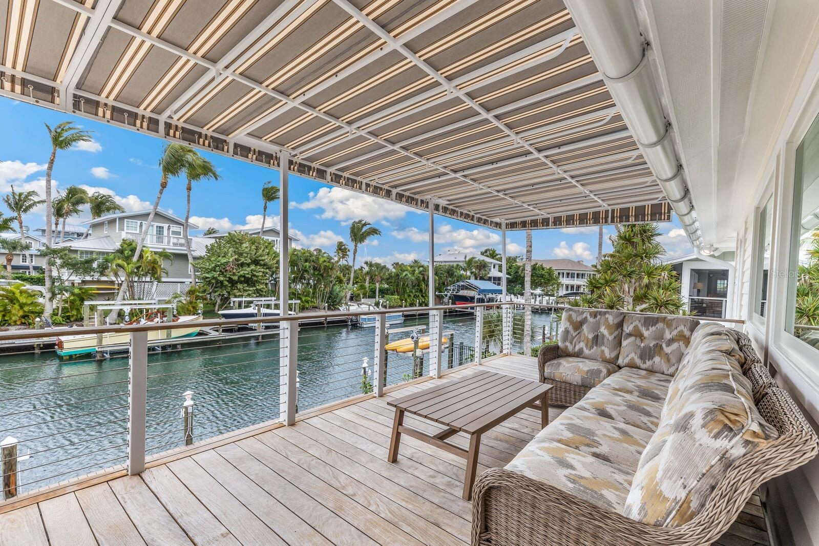 Uncover coastal sophistication in this Yusk-built residence that elevates beyond the ordinary, capturing the essence of Boca Grande living. Brimming with warmth and character, this home invites you to savor a life well-lived by the water's edge. Encompassing approximately 2200 square feet plus an additional bonus area, this charming home effortlessly fuses refinement with functionality. With three bedrooms and two bathrooms, it unfolds as a private sanctuary, offering 80 feet of serene waterfront. The private dock, featuring an 8000-pound lift and a convenient platform for kayaks, beckons exploration of serene waterways. Tailored for the discerning homeowner, the new roof, impact windows, Ipe decks, and cedar siding showcase an unwavering commitment to quality. Nestled on a tranquil street, just a short walk from the Historic Village of Boca Grande, this residence is surrounded by the town's renowned old-world charm, pristine beaches, and enduring sense of community. The quaint village, adorned with historic architecture and eclectic boutiques, invites leisurely strolls, while the azure waters present an aquatic playground for boating and fishing enthusiasts. The island, rightfully dubbed the “Tarpon Fishing Capital of the World,” is a paradise for fishing aficionados, boasting a variety of both inshore and direct deep-sea opportunities amidst world-class dining and recreation. This residence invites you to immerse yourself in the allure of Boca Grande living—a genuine sanctuary where coastal elegance harmoniously converges with limitless adventures. Gasparilla Island is nestled on Florida’s Gulf Coast, roughly halfway between Tampa and Fort Myers. This barrier island is a recreation enthusiast’s dream, bordered by the Gulf of Mexico, Charlotte Harbor, Little Gasparilla Pass and Boca Grande Pass. It’s a place where bicycles and golf carts rule the roads and old Florida charm warms both the sand and the heart, with arguably the best tropical climate in the country. The moniker “Tarpon Fishing Capital of the World” is deserved but does not adequately describe the variety of both inshore and direct deep-sea fishing opportunities, set among world-class dining and recreation. The residence is conveniently located just 10 miles from the private Coral Creek Airport and close to Coral Creek Club’s celebrated, Tom Fazio designed, 18-hole golf course.