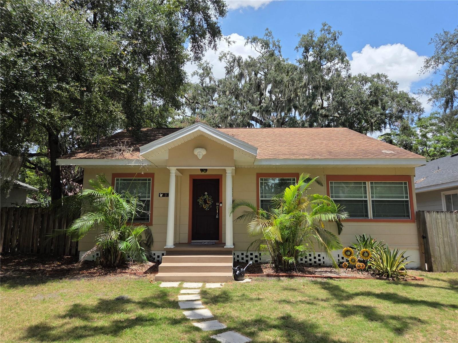 Lovely 1938 two bedroom/1 full bath 1,258 square foot Bungalow with an office/den/flex space that could easily be turned into an additional bedroom. It is situated on a large lot in the prime South Lake Morton Historic District behind the Lakeland Public Library and the Ashley Gibson Barnett Museum of Art at Florida Southern College - close to Lake Morton, restaurants, shops, and vibrant downtown Lakeland! Step into the large living/dining room space with beautiful wood floors and high ceilings with the Travertine-floored office to the right. French doors off of this space lead to the semi-wrap around porch, where you can enjoy the beautiful Florida weather. The kitchen has been remodeled and updated with newer appliances - including a gas stove, beautiful stained glass, and a spacious eating area with a breakfast bar and more French doors to the porch. The bathroom is beautifully remodeled and the plushily carpeted bedrooms are large - with the primary having additional French doors to the porch. The partially fenced peaceful back yard has a Loquat tree, Crape Myrtle, and Live Oaks for shade. The large storage room with washer and dryer has plenty of space for your toys. This home has a transferable termite bond for your peace of mind! Make an appointment to see this charming home, surrounded by history and art in a welcoming area.