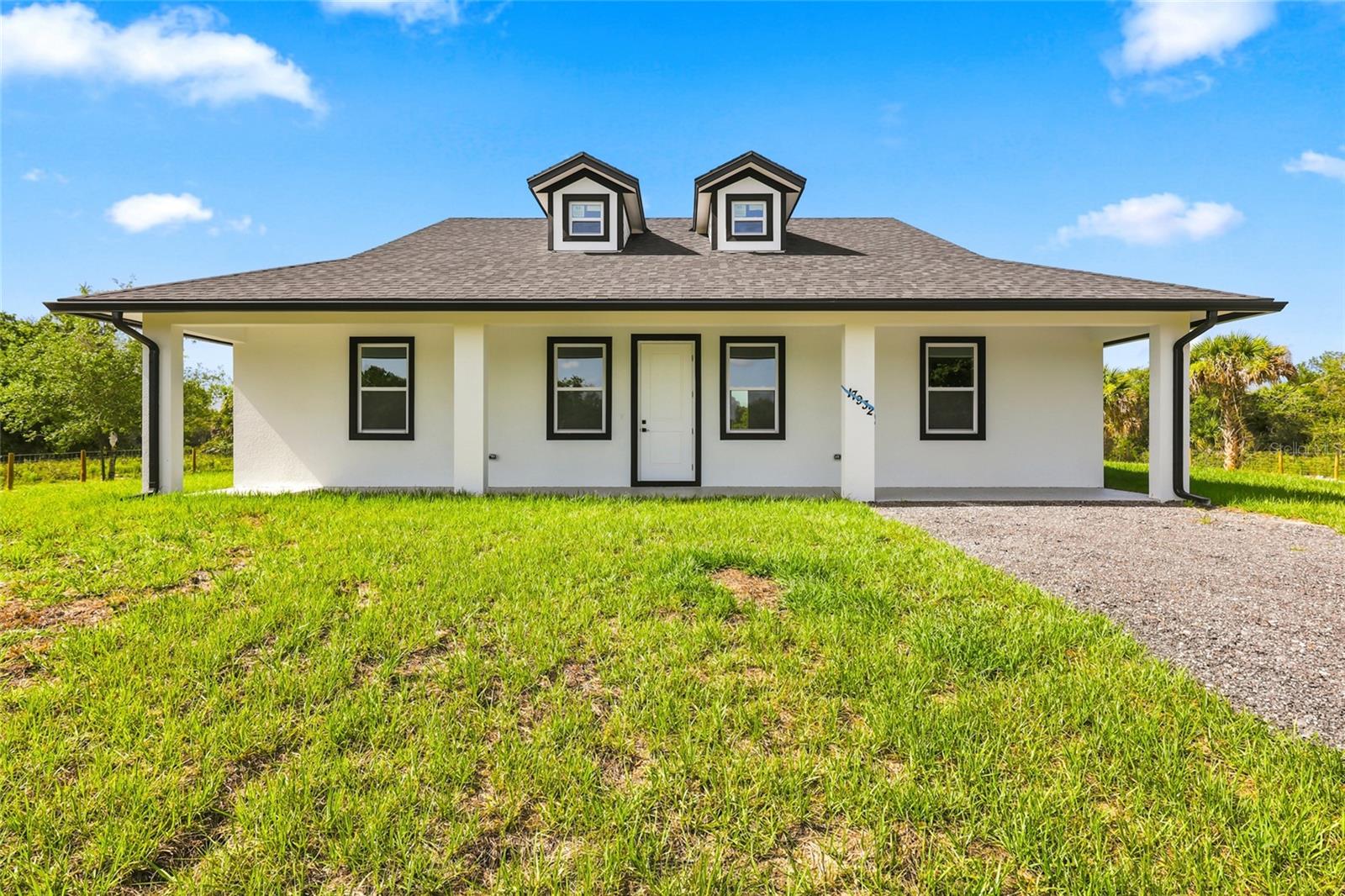 Beautiful brand new 3-bedroom, 2 bath CBS home in Okeechobee featuring 10-foot ceilings and a spacious covered front porch perfect for morning coffee and sunset views. The kitchen offers tall wood cabinets, quartz countertops, and stainless-steel appliances. Interior highlights include tile floors throughout, tiled showers, and sleek black fixtures. Enjoy backyard views from the covered rear porch. Impact windows, central A/C, custom closets and doors complete this move-in ready property. Plenty of room for your boat, RV, or toys.