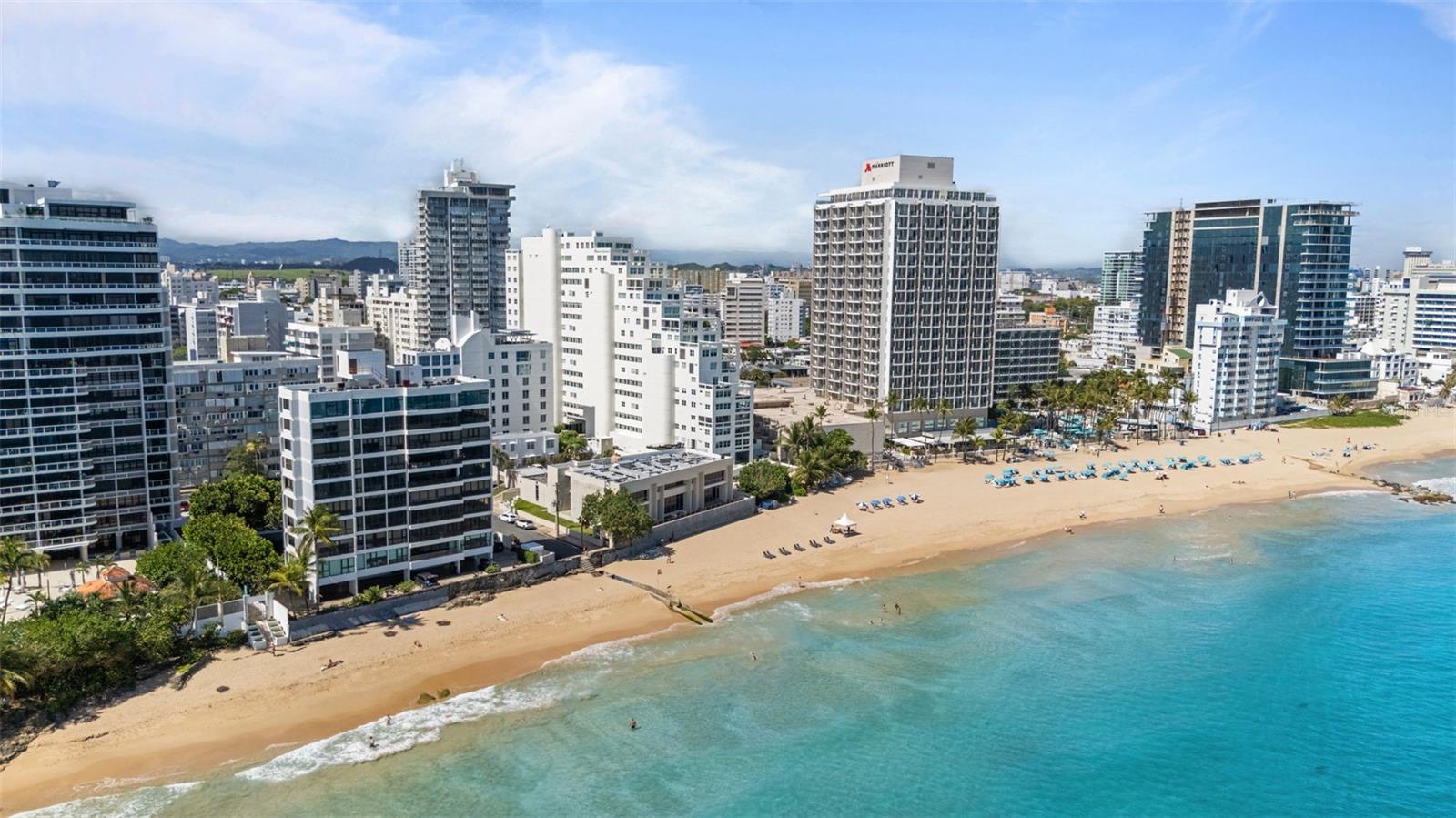 Experience oceanfront living at 1315 Ashford Avenue, Residence 501, in the beautiful Acquamarina Condominium in Condado, San Juan. This hard-to-find residence offers 2,281 square feet of interior space with panoramic ocean views from its main living areas and oversized primary suite.  The three-bedroom, three-bathroom layout is designed to maximize light, views, and functionality. A spacious, integrated living and dining area faces the water, creating a seamless setting for both everyday living and entertaining. Hurricane impact glass windows frame the coastline and open to capture natural light and cross-ventilation, enhancing the connection between the interior and the shoreline.  The modern Italian kitchen is appointed with top-of-the-line appliances including a full size wine cooler providing a streamlined workspace that complements the residence's contemporary design. Elegant marble floors run throughout the home. The primary suite is positioned directly on the ocean, offering a true "on the water" experience.  Residence 501 includes three covered parking spaces.  Acquamarina is a boutique condominium with fewer than 50 residences, offering a private environment along Ashford Avenue. Amenities include an oceanfront pool, direct beach access, and a fully equipped gym. A full power generator and water cistern support uninterrupted building operations. Security features include a biometric access system, 24/7 security personnel, on-site management, and ample visitor parking. Situated in the heart of Condado, this property offers a balanced coastal-urban lifestyle. The building is just a few steps to renowned restaurants, luxury hotels, high-end retail, and a variety of entertainment and service options along Ashford Avenue and the surrounding streets.