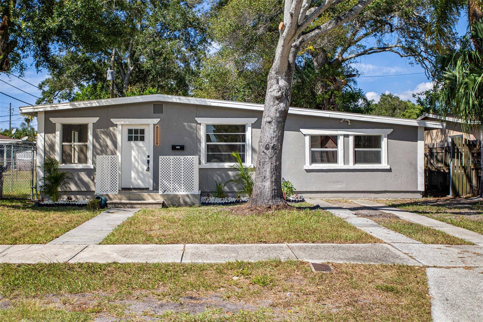 Welcome to your dream home in the heart of sunny St. Petersburg, Florida, just a stone's throw away from picturesque Gulfport Marina and Casino. This prestigiously remodeled property offers a serene and stylish haven for those seeking comfort, convenience, and a taste of coastal living. With its neutral color palette and spacious floorplan, this 3-bedroom, 2-bathroom residence is an oasis just awaiting your personal touch. Nestled on a quiet street, this delightful home boasts 1,188 square feet of living space, perfect for all of your needs. The home has undergone an extensive transformation, both inside and out, making it a true gem in the neighborhood. Freshly painted walls, upgraded fixtures, and modern finishes throughout create a welcoming and move-in-ready atmosphere. The interior is adorned with a tasteful, neutral color scheme and top of the line upgrades, providing a versatile backdrop for your design preferences. The heart of this home is its gourmet kitchen boasting new appliances and ample cabinetry for storage. The eat-at quartz bar adds a contemporary touch, creating a perfect spot for casual dining or entertaining guests. With three well-appointed bedrooms and two modern bathrooms with ornate black stone mosaic shower bottoms, there's ample space for family, guests, or a home office. Enjoy the ultimate privacy with the split bedroom layout. The primary bedroom is situated on one side of the house, while the two additional bedrooms are on the opposite side, providing separation and tranquility. The primary bedroom is a spacious retreat featuring an ensuite bathroom for your convenience plus plenty of closet space. Sliding glass doors open to the backyard, allowing you to savor the Florida sunshine and evening breezes right from your room. Beautiful laminate flooring flows throughout the home creating an easy-to-maintain and clean finish. Nestled in a prime St. Petersburg location, this property is within a short drive of the Gulfport Marina, offering endless opportunities for boating, fishing, and waterfront dining. The area is known for its vibrant arts scene, eclectic shops, and delicious restaurants. You'll also have easy access to the beautiful Gulf Coast beaches, downtown St. Petersburg, and all the amenities this sunny region has to offer. Don't miss this fantastic opportunity to own a newly remodeled, move-in-ready home in the desirable St. Petersburg area. Schedule a showing today and start living the Florida lifestyle you've always dreamed of!