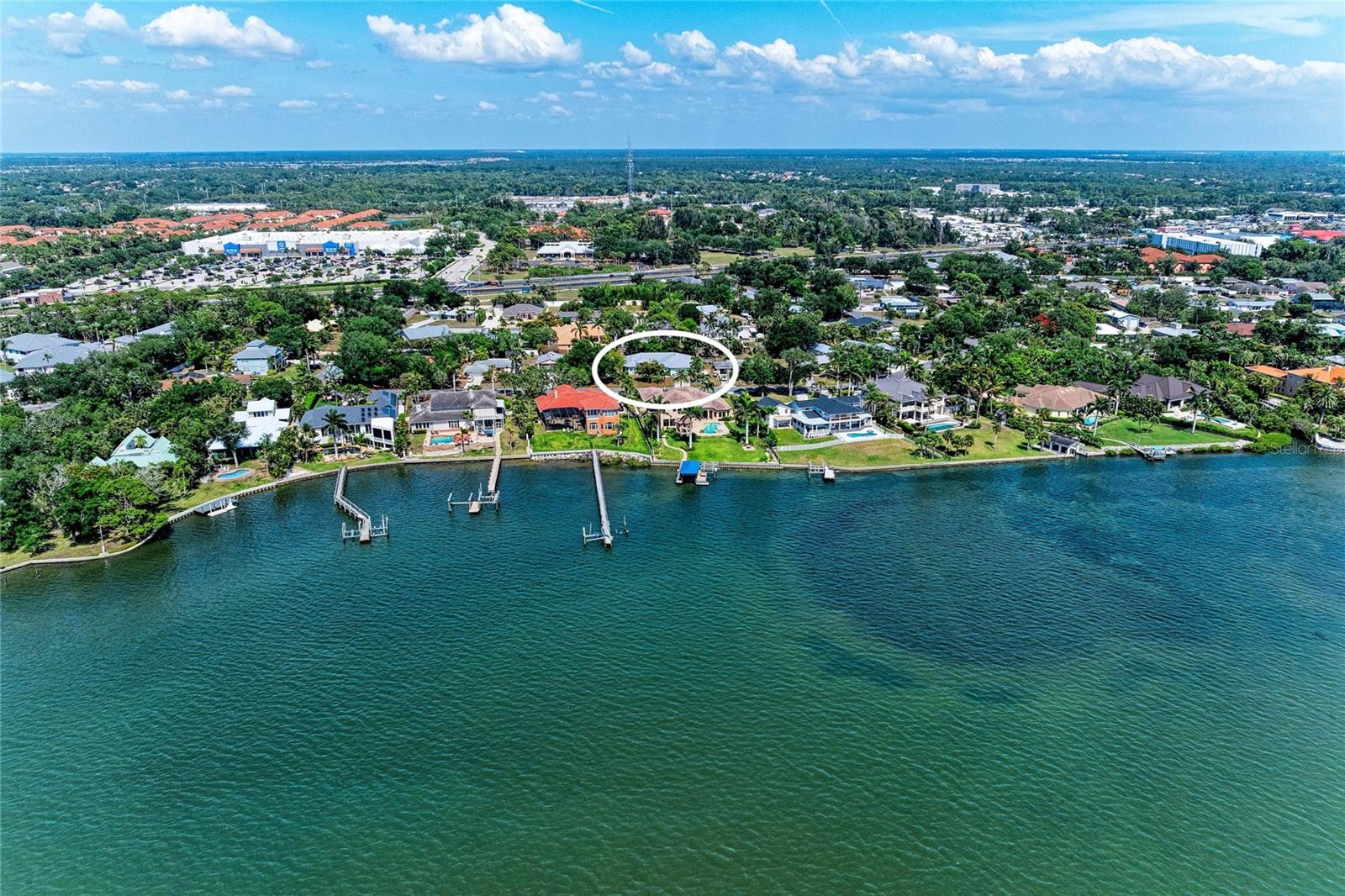 Who needs a space for a possible Mother-In-Law Quarters or a space that could possibly hold 4 plus cars ? 
This is your chance to live West of the Trail in the coveted Bay Acres community.  This waterfront community has no deed restrictions so you can keep your boat or golf cart right on your property.  With over 1400 Sq. Ft. of garage space the possibilities are endless here- use for your 4 plus cars, storage , recreational vehicles or jet skis, or maybe make it into a Mother-In-Law space .  Part of the garage is air conditioned.  The garage plus living space is over 4,000 Sq. Ft.  The home itself has many nice features including a very nice large kitchen, dining room with tray ceiling, floors are gorgeous real Hardwood and wide planked.  This custom built home has impact windows, a metal roof, a large covered porch, and a fenced back yard.   Bay Acres has a waterfront park with boat slips that can be rented for a small yearly fee, Kayak storage and a kayak launch to be out in the Gulf waters in minutes.  This home is ideally located right around the corner from the public Blackburn Point Boat Ramp,  within minutes of many waterfront restaurants, and just 11 miles up the road is Downtown Sarasota.  Come see why this friendly neighborhood and home can make your dreams a reality.