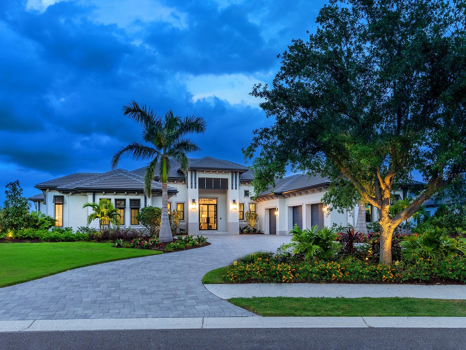 Welcome to this immaculate residence, where every detail has been completely hand-selected and designed for an upscale, contemporary lifestyle within The Lake Club.  This 2023 Stock Custom Homes is one of only a few built by this elite branch of Stock construction in the entire neighborhood; and is offered FULLY FURNISHED with designer furnishings curated by SOCO Interiors.  This one-of-a-kind floor plan features spaces for every need imaginable, wrapped in warm sophistication, including a separate casita, bonus room, study, gym, and 4-car garage with A/C.  Located on over 0.8 acres on a desirable corner lot facing Linear Park, offering a massive side yard with meticulous landscaping; lake views and a conservation area beyond.  From the circular driveway you are welcomed home to a modern elevation where double glass impact doors usher you inside where you’ll see the first glimpses of meticulous design that’s present in every room including custom ceilings, wood detailing, elegant lighting and European oak flooring.  The great room is the heart of the home and the ideal place to gather around the gas fireplace with stone surround, tray ceiling with custom beams and disappearing corner impact sliding glass doors opening to the lanai.  Enjoy breathtaking sunrises from the marble paver lanai with Roman Rock tongue and groove ceilings, classic colonnade screen enclosure, multiple gathering areas, gas fireplace and separate outdoor kitchen and dining space.  The sparkling pool with 360 spill edge spa showcase waterfall features, fire bowls, plus a separate lounging area with fire pit overlooking the lake.  Additional sliders offer a completely seamless flow between the indoors and lanai living space.  The gourmet kitchen has every amenity imaginable with two full islands, custom cabinetry with pots and pans drawers, thick Pompeii quartz counters and backsplash, and hidden storage.  This kitchen is the envy of professional chef’s with top-of-the-line appliances including Wolf wall oven, Wolf steam oven, Cove dishwasher, Wolf 6 burner gas range with 2 dual fuel ovens, Subzero 36” refrigerator and 24” freezer, plus a massive walk-in butler’s pantry with plentiful shelving, cabinetry, and Wolf microwave drawer, Fisher & Paykel dishwasher, and JennAir fridge and freezer drawers.  Dine in style in the dining room surrounded by sliding glass doors and a custom wine bar. The owner’s wing is outfitted with a study with built-in shelving, peninsula desk with Pompeii quartz, plus French doors leading to the lanai.  The primary bedroom is poised for elegant relaxation with custom ceiling, French doors, dual walk-in closets with custom shelving, and spacious spa-like bathroom with modern freestanding tub, thick Pompeii quartz counters, and walk-in shower.  The guest suites in the main home exude their own personal luxury with en-suite bathrooms and walk-in closets.  The rear bonus room is conveniently located off the lanai and has a full pool bathroom.  Don’t forget about the casita with its own private entrance, large living room with kitchenette, full bathroom, and bedroom with French Doors to the lanai. Ingenious upgrades include smart home systems, surround sound, Lutron motorized window treatments, solid pine doors, 20kw generator, impact doors and windows, Kinetico water treatment system with reverse osmosis.  The Lake Club is an exclusive premier, gated community with a Grande Clubhouse, restaurant, pool, tennis, pickleball, fitness and more.