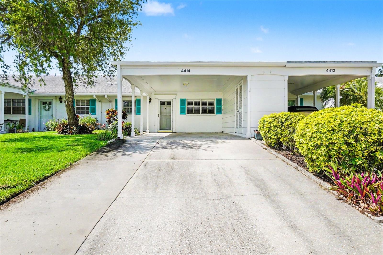 Tucked away in a premier 55+ waterfront community, this beautifully updated villa offers tranquil, partial views of the lake right from your backyard patio, primary bedroom, and spacious Florida room. The pristine interior boasts over 1,350 sq. ft. of living space, plus an enclosed, fully air-conditioned Florida room. Completely move-in ready, the home features modern vinyl flooring, a beautifully updated primary bath, and an open kitchen with a breakfast bar and separate dining area. All your big-ticket mechanicals are already taken care of with a new roof in 2019, hot water heater in 2021, and a brand-new AC system installed in 2022. This ultimate maintenance-free neighborhood offers incredible convenience by covering your cable TV, high-speed internet, water, sewer, trash removal, pest control, and total exterior building maintenance, unlocking a true resort lifestyle with full access to a massive remodeled clubhouse, lakeside veranda, heated pool, spa, sauna, tennis and pickleball courts, a workshop, kayak launch, and a beautiful bayfront park. Offering the perfect blend of a quiet, maintenance-free retreat and an active social community, this villa truly has it all!