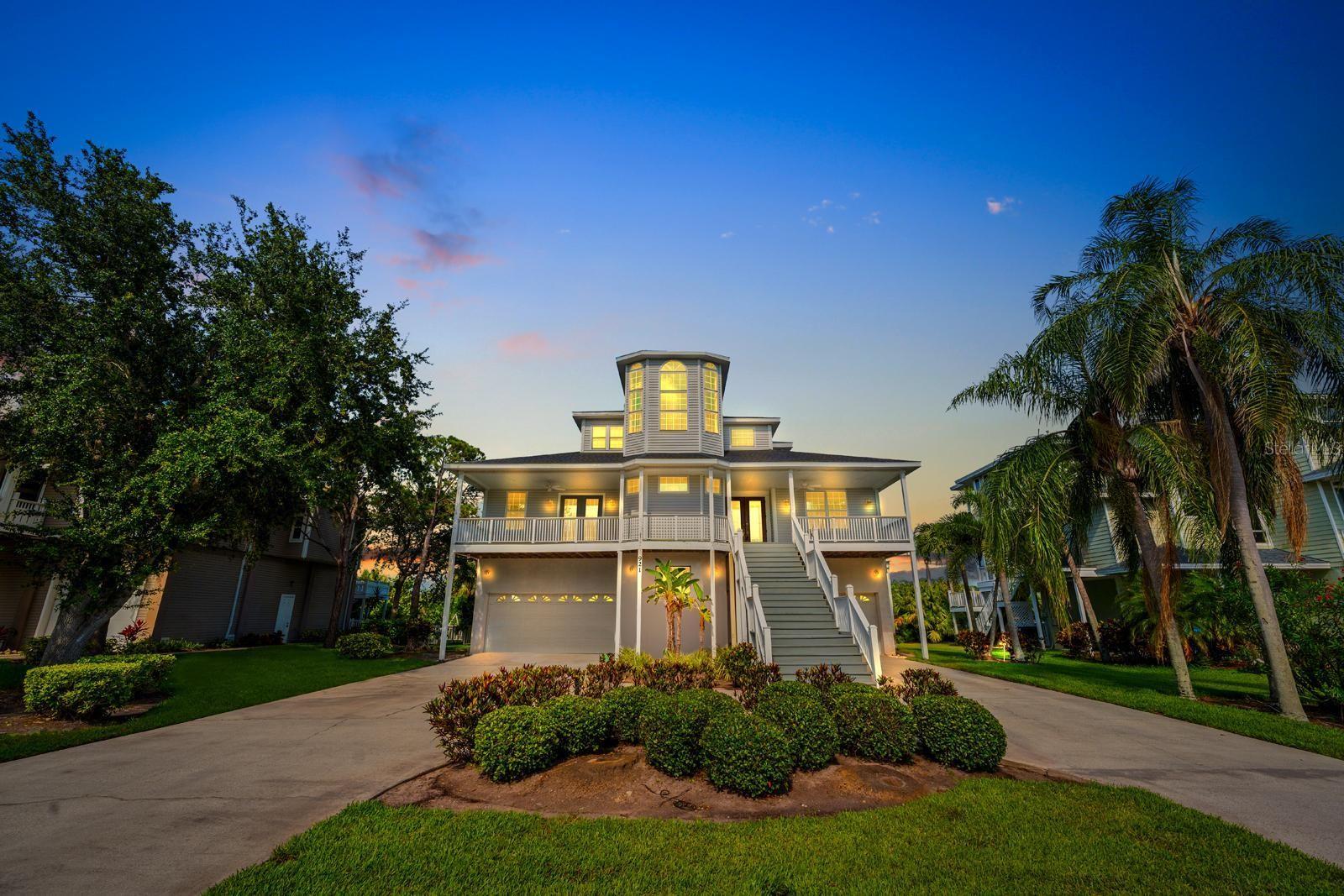 PRIVATE COASTAL RETREAT WITH ELEVATOR, HOME THEATER, SUNSET VIEWS, AND NEARLY 5,000 SQ FT OF FINISHED SPACE IN POINT SEASIDE. Tucked away at the end of a quiet cul-de-sac and backing to a protected nature preserve and bird sanctuary, this exceptional residence offers a rare combination of privacy, space, functionality, and elevated coastal living in the highly sought-after Point Seaside community of Crystal Beach. Featuring 3,612 square feet of living area plus an additional 1,290 square feet of finished lower-level space, this home offers nearly 5,000 square feet of finished enjoyment and flexibility. Designed for both everyday comfort and entertaining, the home includes 4 bedrooms, a dedicated office or flex space, 5.5 bathrooms, soaring ceilings, and multiple indoor and outdoor living areas. A private elevator provides convenient access to all levels, creating long-term functionality and accessibility rarely found in homes of this caliber. The thoughtfully designed floor plan includes multiple gathering spaces, a dedicated home theater, bonus rooms, and direct access to the outdoor living areas. At the heart of the home, the kitchen is complemented by a butler's pantry, custom wet bar, wine storage, Bosch appliances, and generous entertaining spaces that make hosting effortless. Whether enjoying a quiet evening at home or gathering with family and friends, every space has been designed with comfort and connection in mind. The expansive finished lower level provides exceptional flexibility for a home theater, game room, fitness area, hobby space, guest retreat, workshop, multigenerational living, or additional entertainment space. While not included in the official heated living square footage, this finished area significantly enhances the home's overall usability and lifestyle appeal. Additional storage rooms provide ample space for seasonal items, hobbies, and equipment. Step outside to your private outdoor oasis featuring a screened, heated saltwater pool, paver patio, and tranquil preserve views. Multiple balconies capture coastal breezes, Gulf sunsets, and the surrounding natural beauty, creating a seamless indoor outdoor lifestyle that is difficult to replicate. Car enthusiasts, hobbyists, boaters, and golf cart owners will appreciate the oversized 5-car garage configuration, featuring a 4-car tandem garage plus a separate single-car bay ideal for a vehicle, golf cart, workshop, storage, recreational equipment, or waterfront toys. Recent capital improvements provide peace of mind and long-term value, including a new roof in 2023, updated HVAC systems, pool enclosure improvements, a newer water heater, water softener, and reverse osmosis system, and a regularly serviced elevator. Located in a golf cart-friendly community, residents enjoy convenient access to Crystal Beach, Live Oak Park, the waterfront, Pinellas Trail, downtown Palm Harbor, Ozona, Tarpon Springs, Gulf beaches, local restaurants, breweries, marinas, and top-rated schools. Rarely does a home combine privacy, flexibility, accessibility, storage, entertaining space, sunset views, and lifestyle in such a compelling package. This is a unique opportunity to own one of Crystal Beach's most versatile and feature-rich homes.