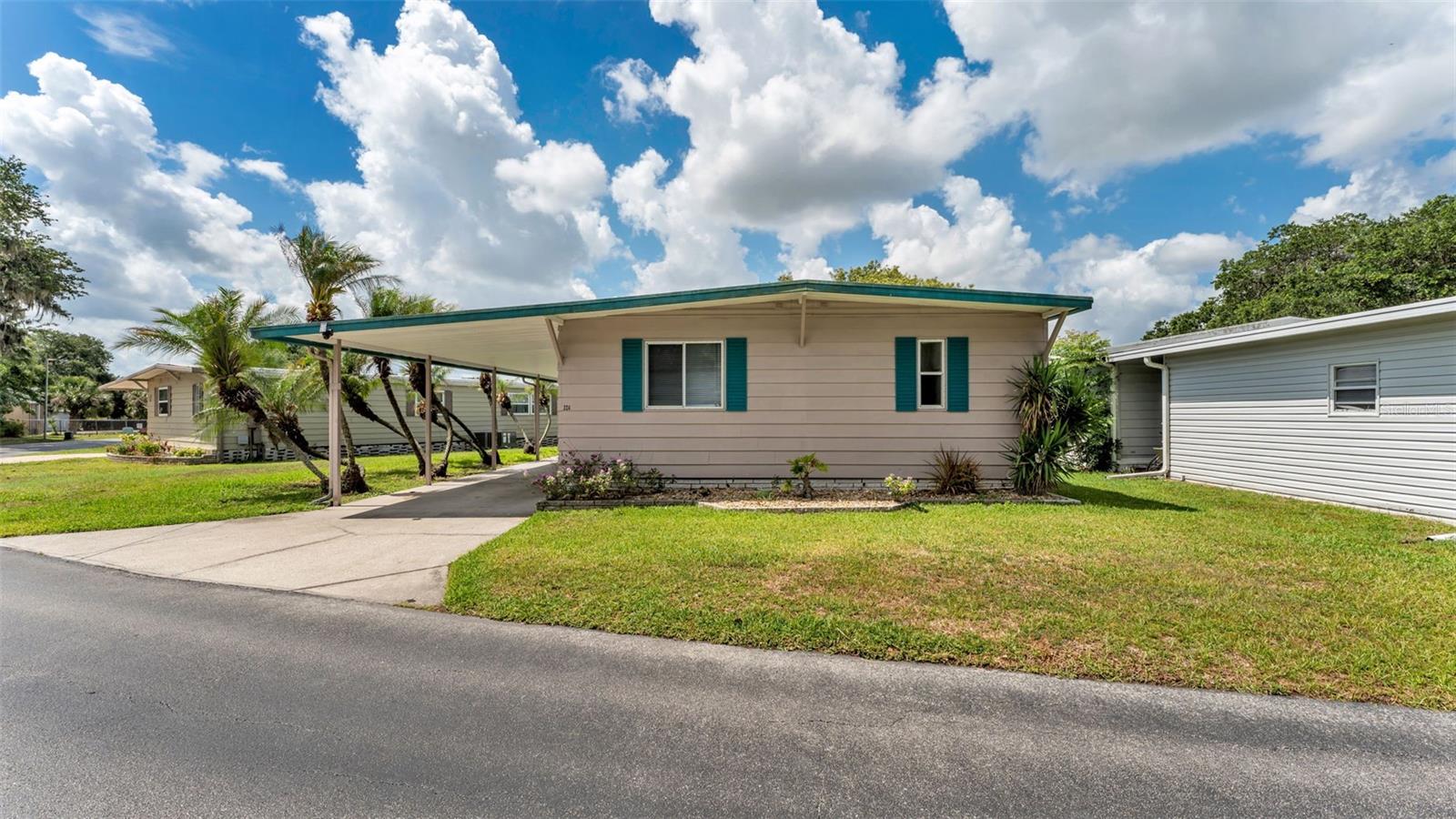 One or more photo(s) has been virtually staged. PRICED TO SELL!!!  Welcome to 2055 South Floral Avenue, Lot 324, located in the desirable 55+ community of Floral Lakes in Bartow, Florida. This beautifully updated 2-bedroom, 2-bathroom lakefront home offers peaceful water views, added privacy, and no rear neighbors. A covered carport provides convenience and protection from the weather, while the metal roof and new A/C add valuable peace of mind. Inside, the home features fresh interior paint, new blinds, updated faucets, and a fully updated kitchen complete with new appliances. Both bathrooms have been refreshed with new vanities, giving the home a clean, move-in-ready feel throughout. The attached Florida room is the perfect place to relax, enjoy the lakefront setting, or entertain guests. Conveniently located in Bartow near shopping, dining, medical facilities, and major roadways, this home offers comfort, updates, and a peaceful waterfront setting all in one.