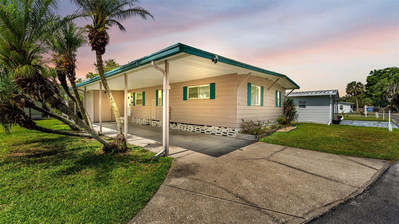 Virtually Staged. Welcome to 2055 South Floral Avenue, Lot 324, located in the desirable 55+ community of Floral Lakes in Bartow, Florida. This beautifully updated 2-bedroom, 2-bathroom lakefront home offers peaceful water views, added privacy, and no rear neighbors. A covered carport provides convenience and protection from the weather, while the metal roof and new A/C add valuable peace of mind. Inside, the home features fresh interior paint, new blinds, updated faucets, and a fully updated kitchen complete with new appliances. Both bathrooms have been refreshed with new vanities, giving the home a clean, move-in-ready feel throughout. The attached Florida room is the perfect place to relax, enjoy the lakefront setting, or entertain guests. Conveniently located in Bartow near shopping, dining, medical facilities, and major roadways, this home offers comfort, updates, and a peaceful waterfront setting all in one.