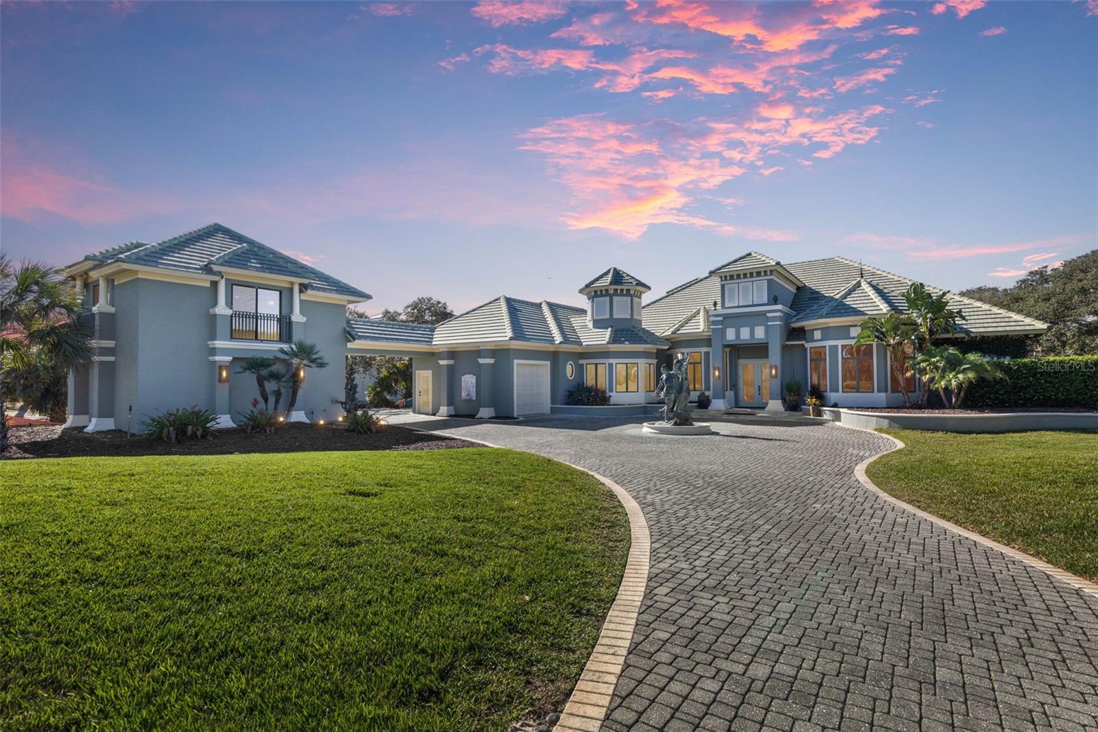 THE SELLER IS HIGHLY MOTIVATED AND WILL ENTERTAIN ALL OFFERS FOR THIS STUNNING INTRACOASTAL ESTATE. Spectacular Intracoastal Pool Estate with Private Dock & Covered Boat Lift
Located within the prestigious gated enclave of Island Estates, this breathtaking, recently renovated five-bedroom, five-and-a-half-bathroom waterfront residence offers a seamless blend of refined design and relaxed coastal luxury, perfectly positioned along the Intracoastal Waterway.
From the moment you arrive, elevated craftsmanship and meticulous attention to detail are immediately apparent. The open-concept layout spans over 5,500 square feet of beautifully curated living space, featuring a formal dining room and an elegant living area highlighted by a fireplace and new porcelain tile flooring throughout.
At the heart of the home, the gourmet chef’s kitchen impresses with Viking stainless steel appliances, an oversized island, a butler’s pantry, and a spacious eat-in dining area—ideal for both intimate gatherings and grand entertaining. Soaring ceilings and a dramatic wall of glass doors flood the living areas with natural light while seamlessly connecting indoor living to the waterfront outdoors.
Designed for unforgettable entertaining, the expansive screened lanai offers wrap-around lounging and dining areas, an outdoor gas fireplace, and an exceptional summer kitchen complete with a wine cooler and premium finishes. The solar-heated saltwater infinity-edge pool, accented by tranquil water features, overlooks sweeping Intracoastal views.
The primary suite serves as a private waterfront sanctuary, offering tranquil water views and a spa-inspired ensuite featuring a luxurious soaking tub overlooking a secluded secret garden, a beautifully appointed walk-in shower, and an additional sunlit steam shower. Three additional bedrooms—two with ensuite baths and one offering flexibility as an office or media room—along with private guest or in-law quarters positioned above the two-car garage with a separate entrance, complete the interior living spaces. A third garage bay, currently designed as a private home gym, is seamlessly connected to the main residence.
A second-story lookout provides panoramic views of the Intracoastal and nearby beaches, creating a spectacular vantage point for both sunrise and sunset. Outdoors, the property is further enhanced by a private dock featuring a brand-new covered 16,000-lb boat lift, along with both covered and open seating areas perfect for waterfront relaxation. Two fire pits in the backyard add warmth and ambiance to the serene setting. Additional highlights include 2023 A/C systems, a new hot water heater, and thoughtful upgrades throughout.
This exceptional Florida estate represents a rare waterfront offering—ideally located near pristine beaches, world-class golf, and the very best of coastal living.