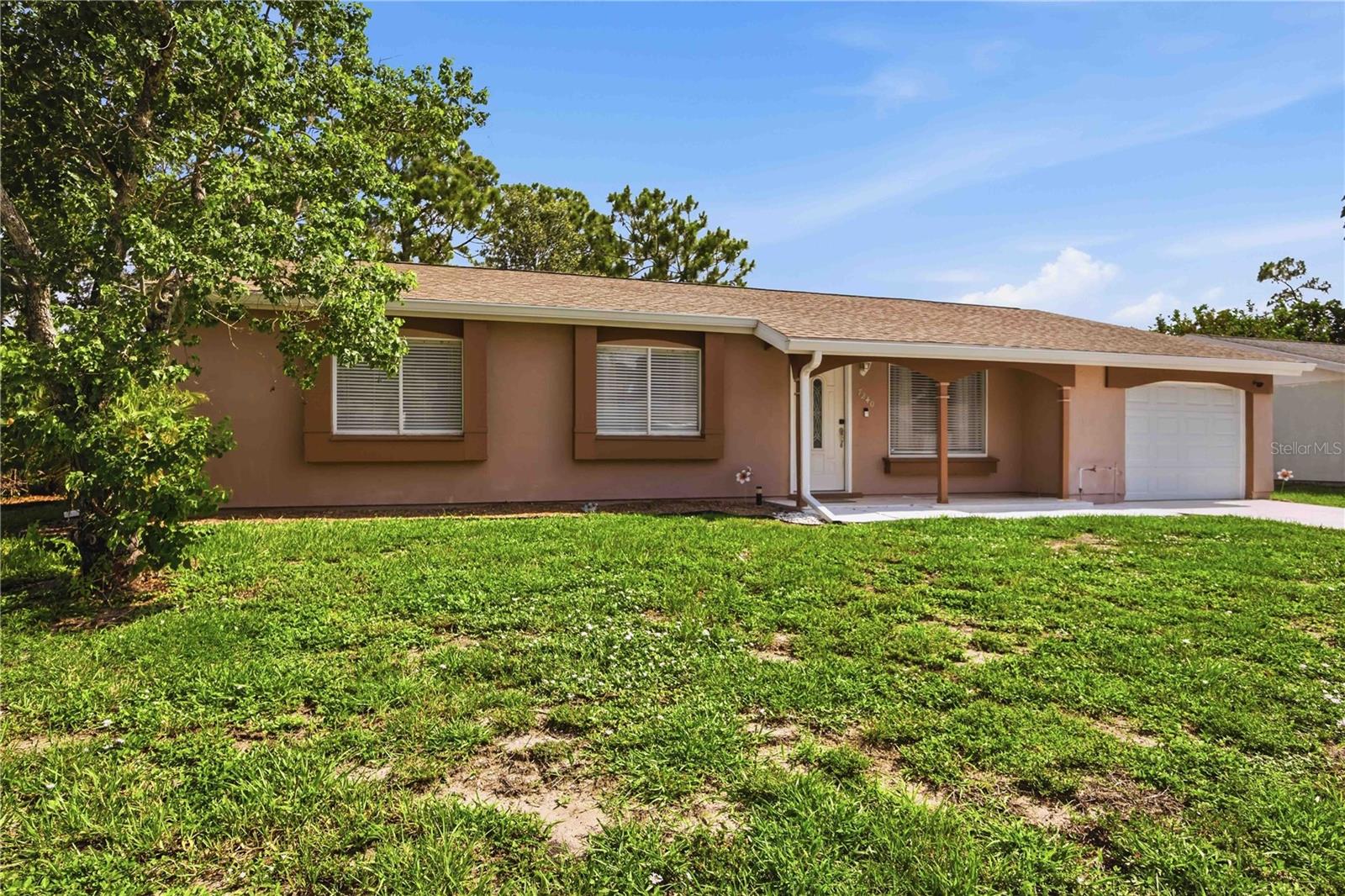 Looking for the perfect inexpensive community with a pool? You've found this 3/2 home with a garage. Entering into this home you'll really be able to see yourself enjoying the Florida life. The living room and connected dining room have sliders out to a screened lanai and large windows, so lots of natural sunlight fill this home with the Florida sparkle. With three bedrooms (2026 carpet!) and two bathrooms, you'll have lots of room for everyone to have their own space, or to house your hobbies! Both bathrooms have updated vanities and tile shower while the primary bath even has glass doors! Looking for some outdoor relaxation space, you'll have a large lot of 10,000 sqft and a screened-in lanai to enjoy it! The Jockey Club community features low-fee living with only $300/year for many amenities: "Our clubhouse is surrounded by beautiful open fields offering a variety of amenities for our residents such as a full size swimming pool, tennis and basketball courts, shuffleboard, cornhole, horseshoes, & grilling station.~Jockey Club of North Port". In less than a mile, the Garden of Five Senses is just outside of your neighborhood and features a fantastic playground with a pavillion, paved walking trails and landscaping to awaken your five senses.
