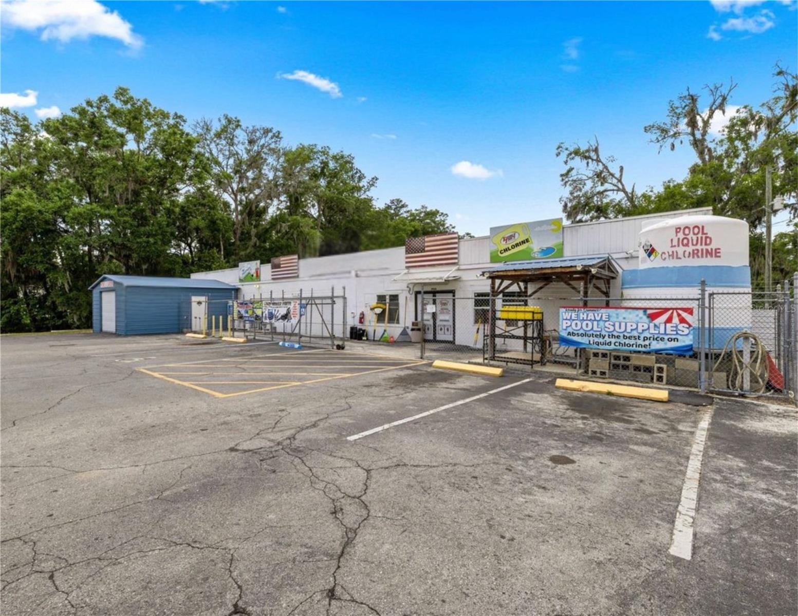 Prime opportunity to own a versatile commercial property with strong existing infrastructure and income possibilities. This 4,216 sq ft concrete block building is currently operating as a hardware store and sits on a .61-acre parcel, offering excellent visibility and accessibility.
Included in the sale is an adjoining .56-acre parcel, currently utilized as overflow parking and an outdoor event space—providing added flexibility for expansion, additional business ventures, or increased customer capacity. AADT is 12,900 cars per day (FDOT)
The property features a new roof installed in 2021, two metal storage buildings, and valuable operational components including propane and chlorine tank dispensary systems that will convey with the sale.
Zoned B2 and B4, this property allows for a wide range of commercial uses, making it ideal for retail, and service-based businesses.
