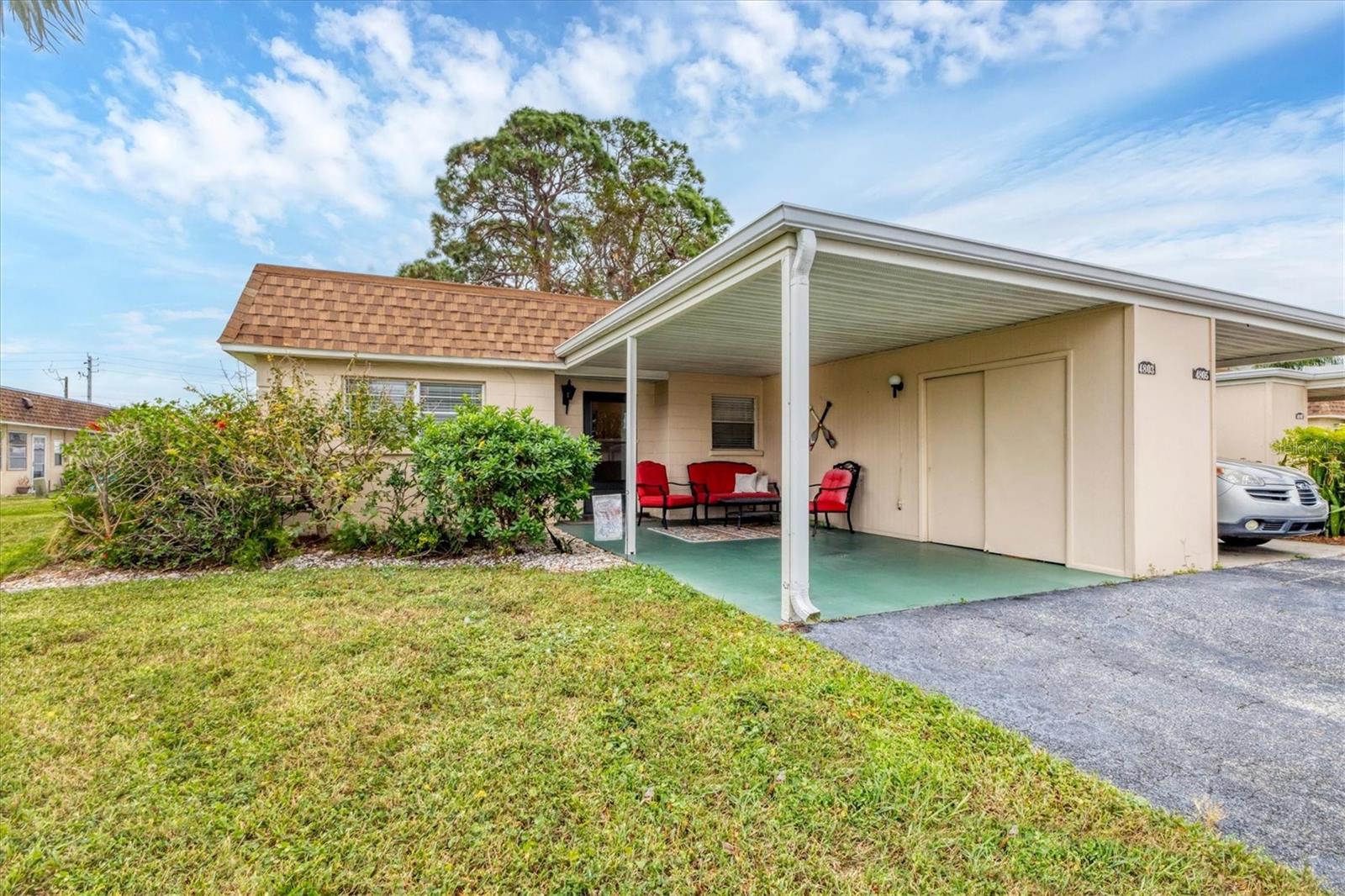 Experience the Florida lifestyle in this affordable maintenance free home, perfect for either snowbird or year-round living! This charming 2/2 end unit villa is sturdy concrete block construction with attached carport, exterior storage and additional parking in driveway. Desirable location directly across from the community clubhouse/pool. New luxury vinyl plank along with tile flooring throughout for easy maintenance as well as an updated guest bath. Ideal floor plan with living/dining room combination and split plan for privacy. The spacious master bedroom has en suite bath with step in shower and a walk-in closet. The glass enclosed Florida room offers an additional sunny flex space with an exterior door and laundry closet with full size washer and dryer. Brand new roof/gutters in 2025, and AC is 2019. This vibrant 55+ pet friendly community has a heated community pool for year-round enjoyment, clubhouse and shuffleboard. Fees include exterior maintenance, cable and internet, recreation facilities, trash/recycle and manager. Great central location in West Bradenton convenient to shopping, restaurants, hospitals, public transportation, downtown Bradenton/Riverwalk and SRQ Airport. Don't miss this opportunity!