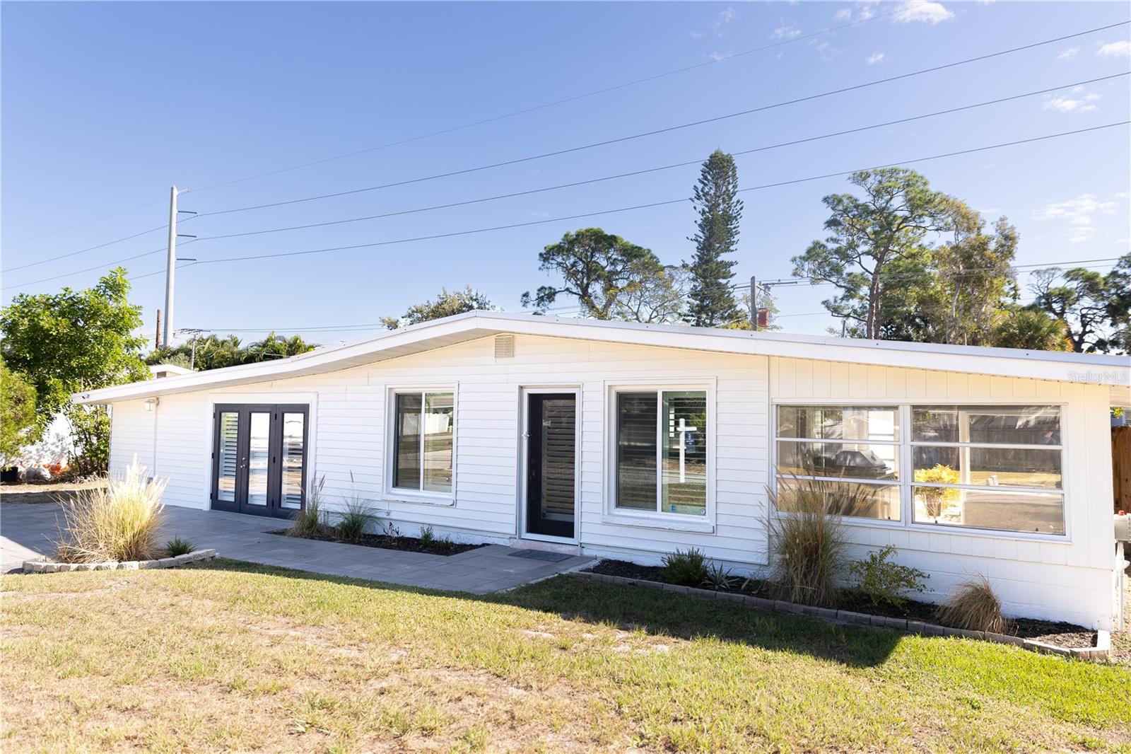 Welcome to 8717 Peggy Avenue! This charming house is now available for sale in the neighborhood of Tropical Shores. Boasting a cost-effective boating community, this property offers a fantastic opportunity to enjoy the Florida lifestyle.

With three bedrooms and two bathrooms, this house provides ample space for comfortable living. The 2017 comprehensive remodeling ensures that you'll have peace of mind with new features such as a roof, AC unit, and windows. Additionally, you'll benefit from newer amenities like a reverse osmosis water filtration system, whole house water softener, and septic system.

Inside, the freshly painted interior creates a welcoming atmosphere. The split plan layout offers privacy, with the primary suite featuring an updated ensuite bathroom and sitting area. The other two bedrooms are located on the opposite side of the house, along with an additional upgraded full bathroom.

As you step outside, you'll find that recently refreshed landscaping and fenced yard perfect for privacy and security. Enjoy outdoor gatherings with family and friends on the two patios while savoring delicious meals prepared on the grill. Need extra storage? No problem! This property also includes a convenient storage shed.

Living in Tropical Shores comes with exciting perks. Take advantage of the boating and kayak access.  Inn addition there are boat slips, kayak racks, and a boat ramp and club house available for an additional fee ranging from $275 to $1100 annually.

Don't miss out on this incredible opportunity to own a home in Tropical Shores