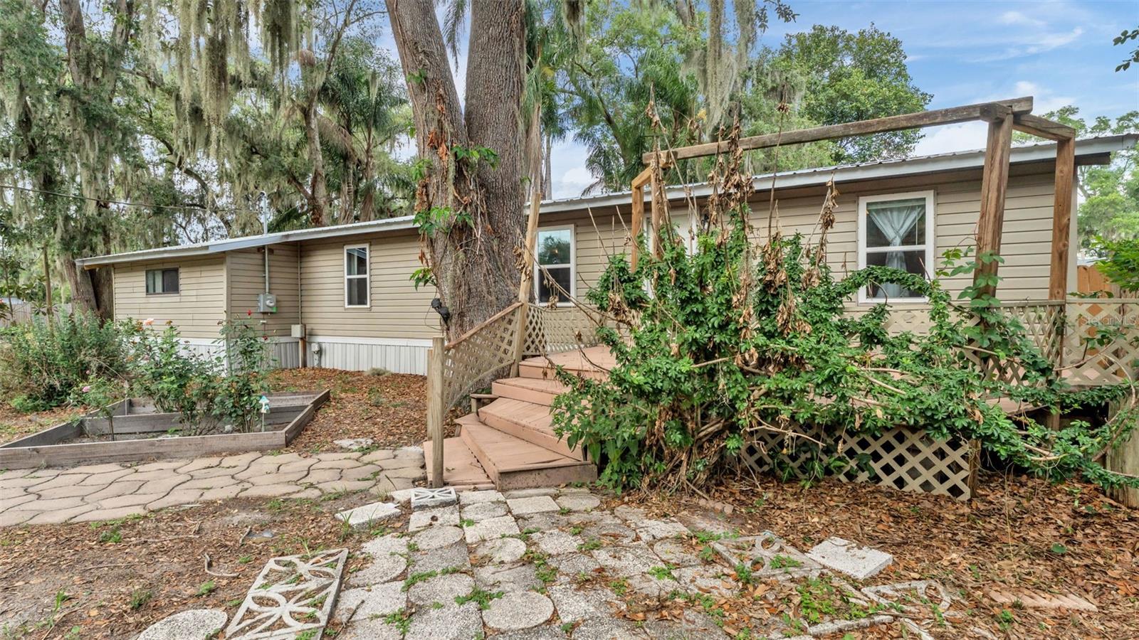 Welcome to this well-maintained 3 bedroom, 2 bathroom manufactured home offering a comfortable split floor plan, spacious living room, and an open kitchen ideal for everyday living. A separate flex space provides the perfect setup for a home office, study area, or creative workspace. Recent upgrades include a metal roof and a new HVAC system installed in 2025, giving buyers peace of mind and long-term value. What truly sets this property apart is the rare opportunity to own the adjacent lot, included with the sale. The additional parcel currently features a large workshop and a previous septic system, making it an excellent setup for placing a brand-new manufactured home. Whether you’re looking to create a multi-generational living arrangement, expand your investment portfolio, or generate rental income, the possibilities are exceptional—live in one and rent the other. With flexible use options, valuable improvements, and room to grow, this property offers a unique chance to secure space, versatility, and future potential in one package.