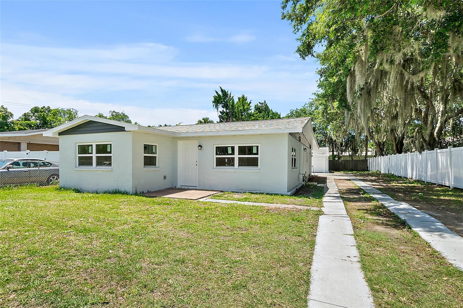 Don't miss this home in sought-after New Smyrna Beach. This 2 bedroom, 1.5 bath home features both formal and informal living spaces. This home is in an amazing central location just a short drive from the soft sands and rolling ocean waves, offering easy access to the best that both the beachside and mainland areas have to offer! At your fingertips in this central location are some of the area's best beaches, restaurants, shopping spots and tourist attractions! Here you'll enjoy serving up meals in the updated kitchen boasting plenty of cabinet and counter space, and white appliances. When night falls, the master bedroom is an oasis with updated ensuite ½ bath. The home also offers a guest bedroom and a beautifully updated full bath. Buyers will have peace of mind with NEW windows and NEW flooring. Outside offers a covered screened in back porch and access to the 4 car detached garage offering plenty of room for your beach toys, lifestyle gear, tools or a workshop plus a parking pad with space for multiple cars, your boat, trailer, RV or other recreational vehicles. Act now and this beautiful home could be YOURS!