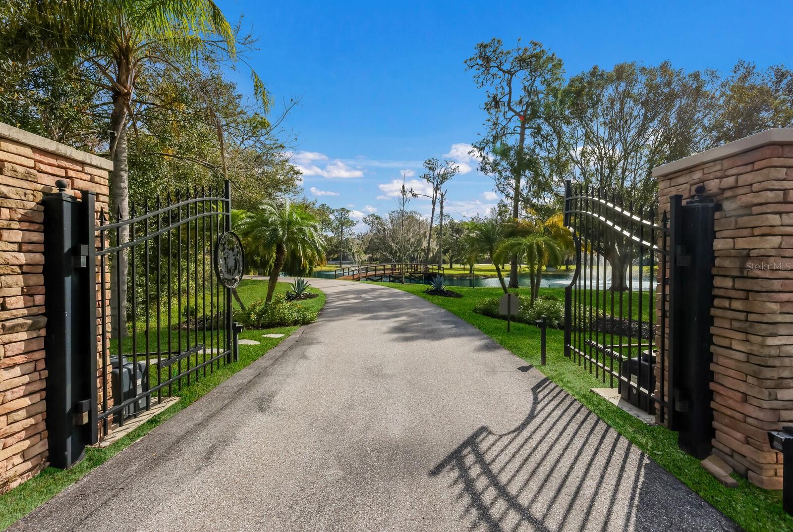 Nestled within the highly sought after equestrian community of The Forest at Panther Ridge, 6605 189th St E is a captivating 7.88 acre, fully fenced, residence that seamlessly blends luxurious living with the tranquility of a natural haven. From the moment you drive through the gates of this breathtaking property, boasting acres of Florida native and friendly flora landscaping, designed, and maintained by a Master Gardener, you will be transported to a world filled with unparalleled beauty resembling a botanical retreat. Imagine waking up to the sounds of nature and enjoying evenings under starlit skies or taking a stroll to your custom gazebo to watch the deer frolic and play. This custom designed residence and guest house offers 5,338 square feet under air and 7,674 sq ft total! Both the main home and guest home were thoughtfully renovated with no expense spared in 2019. This sprawling estate exudes a warm country lodge vibe with a modern elegance interior. The primary home offers three bedrooms all ensuite, a charming office with views of the one-acre pond with fountains and 66' custom bridge, an impressive theater room, chef’s kitchen complete with ice maker, gas Wolf industrial oven, and Subzero refrigerator.  The family room is cozy yet elegant with authentic wood beams and a wood burning fireplace with gas starter. You will love the three car garage with custom built-ins and high-quality epoxy flooring. The unique material choices include stunning wide plank wood flooring, exquisite lighting creating a story throughout the home and ambiance for every occasion, custom brick wall in the dining room exuding old world charm and authenticity are a few favorites!  The unrivaled selections are the perfect blend of form and function. The outdoor living space is a tropical oasis featuring an outdoor kitchen, heated saltwater pool, with fiber optics lighting options, spa, sun shelf, and captivating waterfall feature with custom pergola with motorized louvers.  The travertine deck sets the stage for entertaining in the company of nature and under the “twinkle lights” pool cage creating a memorable evening with friends & family. The 2019 metal roof, impact PGT windows and doors, 35 KW whole house generator, spray foam Icynene insulation, MESH WIFI and 16 security cameras give peace of mind to the most discerning buyer looking for the ultimate in security and efficiency.  The two-bedroom guest home attached to the air-conditioned, 4 car garage will delight car enthusiasts and offers endless options for storage, gym and more. Your guests won’t want to leave this charming cottage with a full kitchen with quartz counters, wood shaker cabinets and cozy screened porch for morning coffee or nights gazing at stars. Venture out to the cutest “she shed” you will ever see and admire the beautiful garden that only a Master Gardener could so eloquently create. The property is an experience and truly can’t be described in words. The pride in ownership of this storybook residence is apparent and nothing short of a tranquil oasis where resort living converges in perfect harmony with the serenity of nature.  Panther Ridge is a sanctuary for those seeking a peaceful setting within nature, while still being just minutes to a multitude of amenities in neighboring Lakewood Ranch. The combination of stunning acreage, location, and two fully renovated living areas make this property a very rare find. Why not have the best of all worlds in this magical setting?