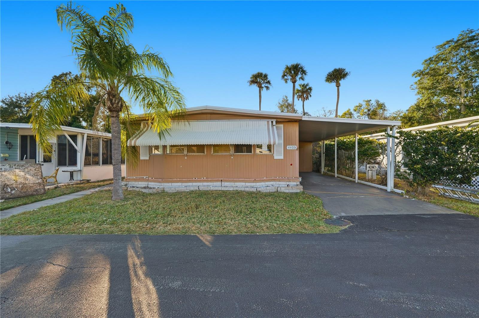 Opportunity awaits in the 55+ community of Place in the Sun with this 2-bedroom, 2-bathroom mobile home offering 960 square feet of living space in New Port Richey. This home requires remediation, but features a functional layout and good bones, making it a great option for those looking to customize and add value. This is a great opportunity to purchase a home at an extreme discount and customize every finished detail while preserving long term equity. The home offers carport parking along with an additional storage closet for convenience. Inside, you’ll find an open floor plan that provides a comfortable flow between the living and dining areas. The spacious primary bedroom includes a walk-in closet and a private, attached bathroom, while the second bedroom and bathroom offer flexibility for guests or hobbies. Outside, enjoy a paved patio - perfect for relaxing, entertaining, or enjoying Florida’s warm weather. The community offers a variety of amenities, including a HEATED POOL, shuffleboard courts, clubhouse, and grilling area, creating an active and social lifestyle. Ideally located close to Eagle Point Park with a kayak launch, as well as nearby dining options and shopping centers, this home offers both convenience and recreation. HOA fees include cable, internet, and more, adding to the value. With updates and personal touches, this property has great potential in a desirable 55+ community. Schedule your showing today.