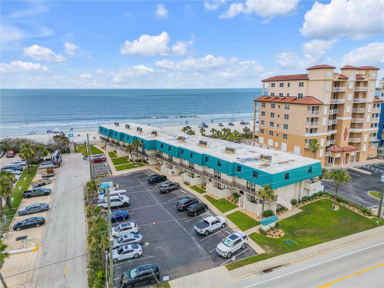 Wake up to breathtaking oceanfront views from this stunning top-floor, two-story condo in the highly sought-after Coronado Del Mar community of New Smyrna Beach. Whether you're searching for a coastal retreat or a proven short-term rental investment, this beautifully designed 2-bedroom, 2.5-bath residence offers the perfect combination of comfort, style, and income potential. The well-appointed kitchen opens seamlessly into the spacious dining and living areas, creating an inviting space for relaxing or entertaining. Expansive sliding glass doors fill the home with natural light and frame spectacular views of the beach, sparkling Atlantic Ocean, and community pool. A convenient half bath completes the main level. Upstairs, both generously sized bedrooms feature private en suite bathrooms and incredible ocean views, providing a peaceful retreat for owners and guests alike. The spacious balcony is the perfect place to enjoy morning coffee, unwind with the ocean breeze, or take in unforgettable sunrises overlooking the pool and shoreline. With a proven track record as a successful short-term rental, this exceptional property offers outstanding investment potential while delivering the ultimate beach lifestyle. Ideally located near local restaurants, grocery stores, shopping, entertainment, and everything New Smyrna Beach is known for, this is a rare opportunity to own a piece of paradise with unforgettable oceanfront scenery. Mortgage savings may be available for buyers of this listing.