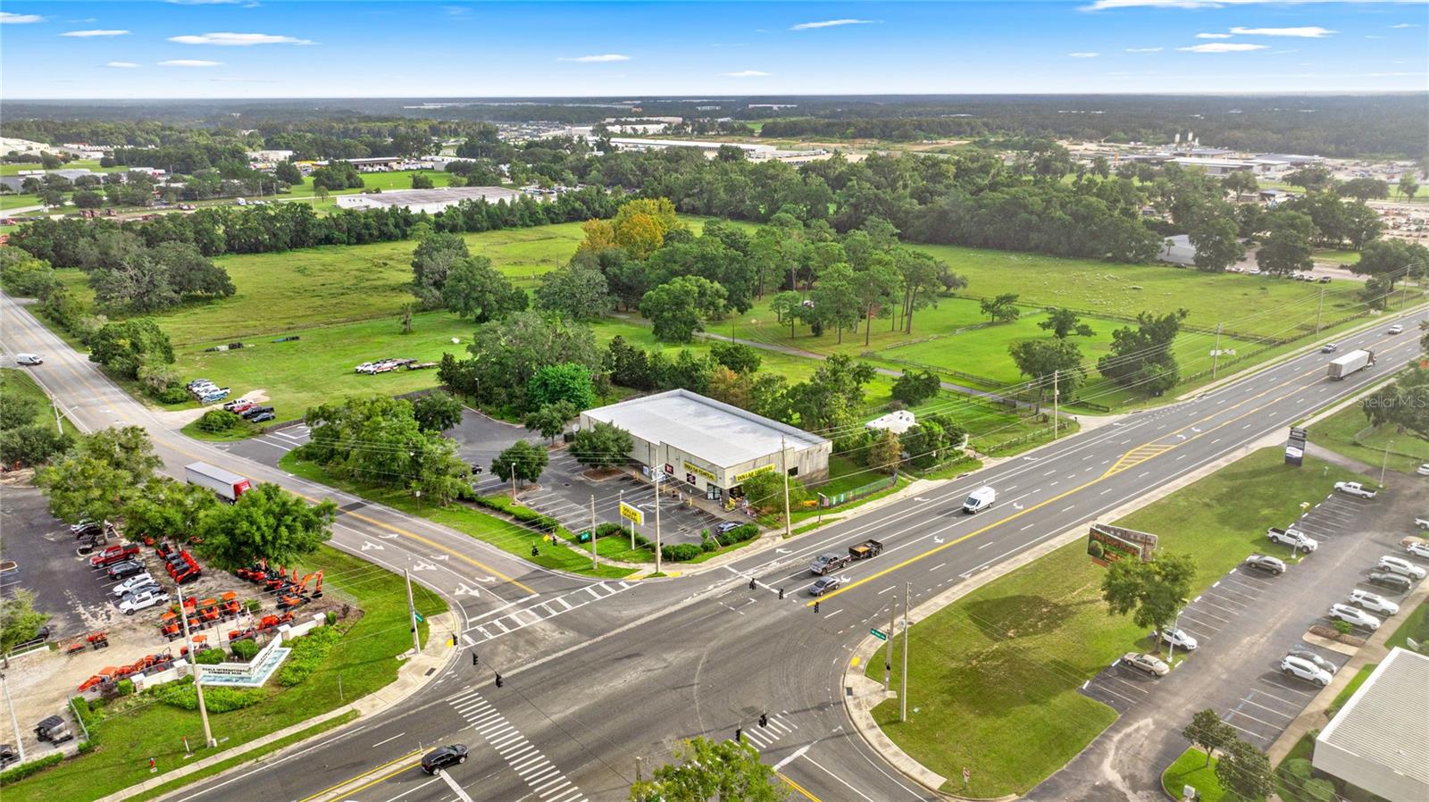 A rare opportunity to secure a large land tract with access via a signalized intersection at NW 52nd Ave just off of W Hwy 40! This 25.00 +/- acres of high-visibility land is currently being rezoned to M-1 Industrial. Parcel could be split into as low as 12 acres (+/-) or can be sold as the estimated 25 acre larger tract. Strategically located in one of Marion County’s most active growth areas, this exceptional site offers outstanding development potential. With very close proximity to several large industrial developments like the Ocala Airport Commerce Park, the Ocala International Commerce Park, and Meadowbrook Industrial Park, the location is unmatched! With a premier location right in the main ‘’hub” of Ocala/Marion County’s most sought after location for large corporations seeking ease of transportation, available workforce, and  economic growth, this parcel offers excellent opportunities for long term sustainability. Truck access to the property is easy configurable, and there are no deed restrictions to the property.  Excellent proximity to the I-75 interchange at Hwy 40, as well as easy access to several other highly traveled roads through the booming Ocala area. The property features excellent access from W Hwy 40 (a major traffic artery), and is surrounded by extensive shopping, dining, and service amenities.  There is a City of Ocala Sewer Force Main adjacent to the property on NW 52nd Avenue , a Gravity Main, Manholes, and Sewer in the center on NW 52nd Avenue with laterals to the property. Additionally, a City of Ocala 16” Water Line is across NW 52nd Avenue with laterals in place to the property and hydrants located along NW 52nd Avenue. The area boasts strong demographics, above-average rooftop counts, and close proximity to a large of amount of both new and existing construction projects. With its combination of size, accessibility, and market exposure, this parcel is ideally suited for a landmark project in a high-demand location.