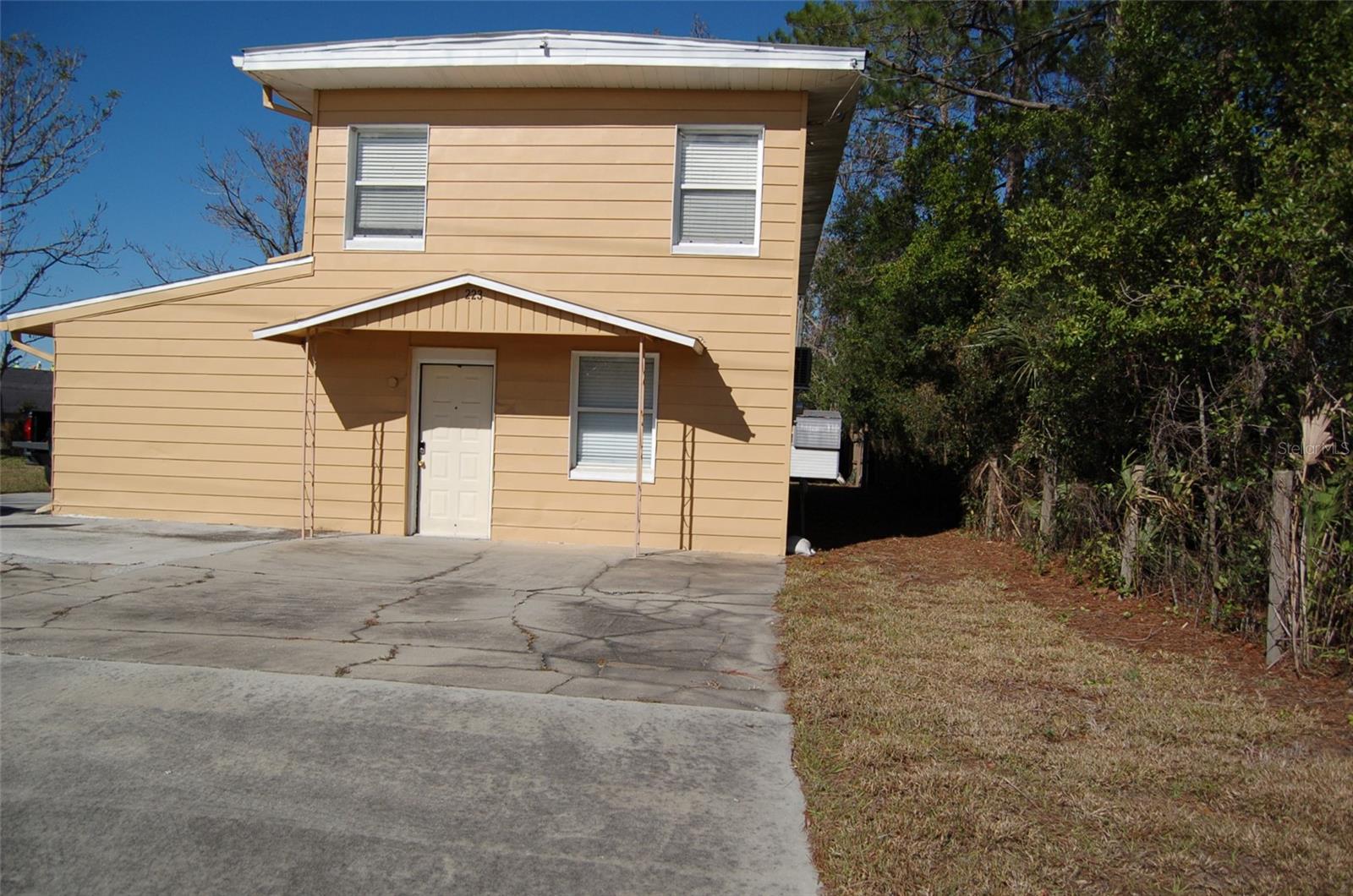 walking distance to the villages Publix, can be use as commercial. 2 bedrooms on second level with 1 full bath and kitchen. First floor also have kitchen with 1 bedroom and 1 1/2 bath and an office room can be use as the second bedroom just no closet. There is a lot of potential for this property.