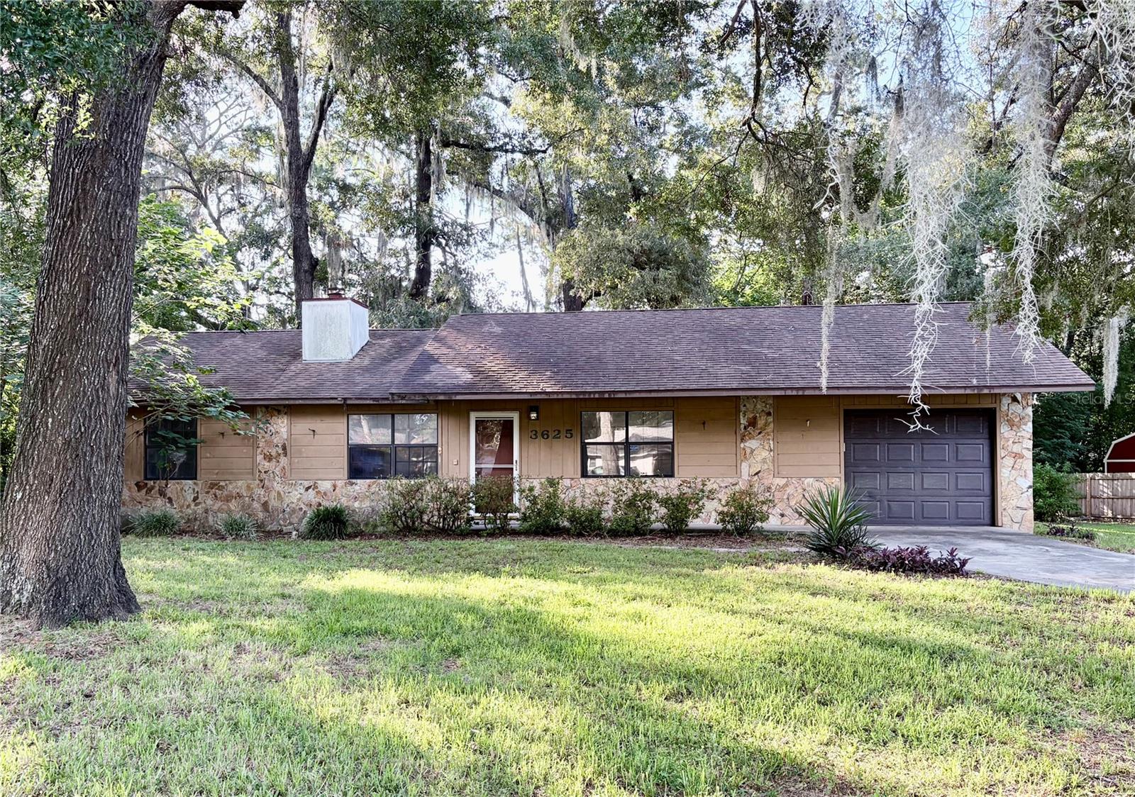 Opportunity! Whether you're searching for a first home, an investment property, or a future rental, this 3-bedroom, 2-bath home offers solid bones and the chance to make it your own. Freshly painted throughout, the home features approximately 1,200 square feet of living area with an open great room/dining room floor plan, split bedrooms, high ceilings, and a wood-burning fireplace.

The kitchen includes a separate dining area, breakfast bar, and ample cabinet space. The primary suite offers a walk-in closet and a private bath.  Sliding glass doors in the dining room lead to a patio overlooking the large backyard—providing plenty of room for outdoor living, gardening, or future improvements.

Additional features include a one-car garage with automatic opener and washer and dryer hookups. Located in the established Woodland Place community with no HOA, this home is conveniently situated near Publix, shopping, dining, medical facilities, and everything beautiful Ocala has to offer.

With its desirable layout, great location, and endless potential, this home is ready for its next owner to add their personal touches and make it shine.  (Updated photos are coming soon!)