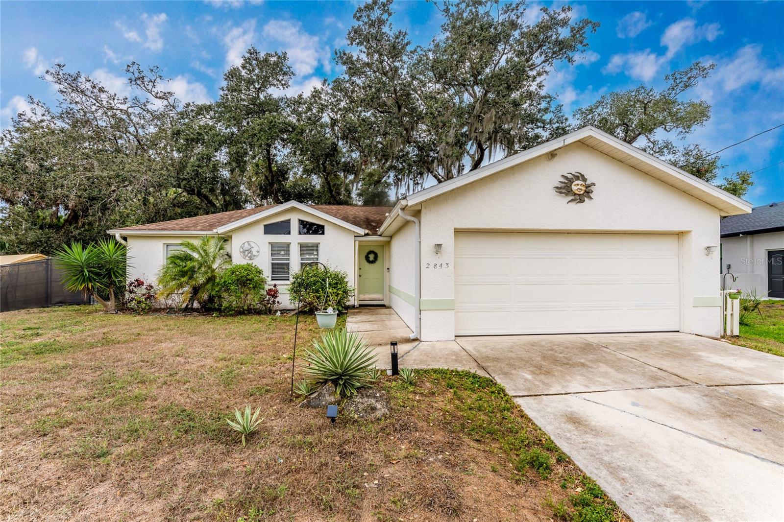 Charming 3 bedroom 2 bath home situated on an oversized lot in Beautiful North Port. Upon opening the door you will feel at home with the soothing colors, high ceilings with windows, giving natural light throughout.  Large open kitchen with stainless steel appliances. Cooking prep area with Butcher Block Counter and additional cabinets for storage. Breakfast bar is a plus. Open floor plan with split bedrooms. Property has beautiful oak trees, mature landscaping and is fenced in for the dog lover.  Relax in the screened lanai under the canopy of trees or use the outside deck to entertain and BBQ. New roof in 2019. 
The City of North Port is home of the Atlanta Braves Spring Training. Visit  Downtown Wellen Park, the Social Hub of North Port, with Eateries, Shopping, Entertainment and Farmers Market on weekends.  Home is minutes to the North Port Aquatic Center, the water park that features a 25-meter stretch pool, three slides, and a lazy river. Centrally located to EVERYTHING...US-41, I-75, schools, Suncoast Technical College, Shannon Staub Library, and plenty of grocery, retail shopping, and dining. Convenient access to a multitude of golf courses, world-class fishing, boating, and stunning Gulf beaches!