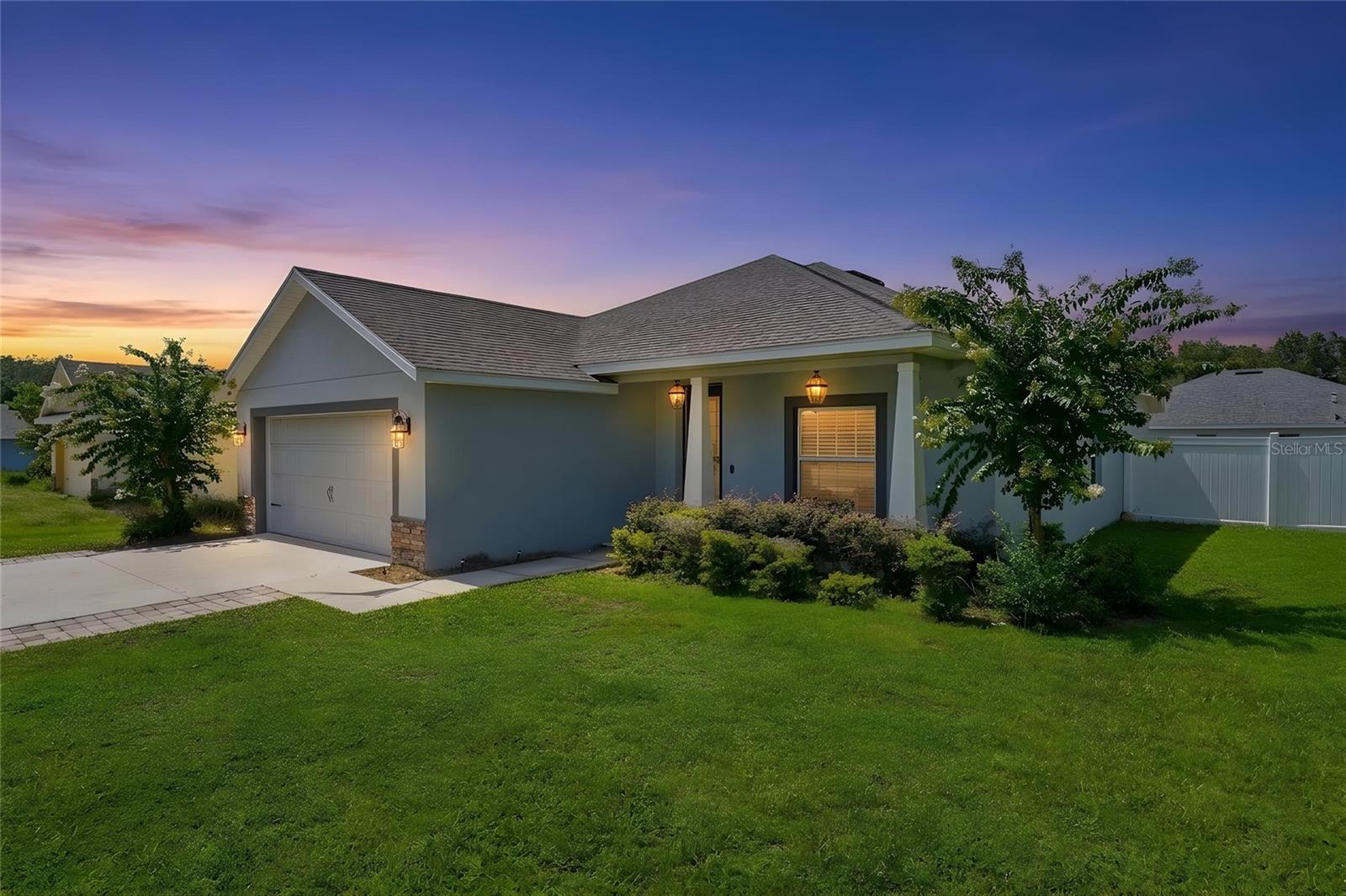 Virtually Staged. Built in 2021, this 3-bedroom, 2-bath home sits on .40 acres in Umatilla with NO HOA and a fully fenced backyard. No carpet here, LVP flooring runs throughout the entire home, and both bathrooms feature updated tile work. The large primary suite includes a MASSIVE walk-in closet with plenty of storage. The home is also set up as a smart home, allowing you to control the lighting, fans, garage doors, and exterior doors with Alexa, along with an upgraded front door lock that can be controlled directly from your phone. Security cameras are already installed for added protection. In the living room, the projector can be used in place of a traditional TV and connects through HDMI or USB for devices such as a Fire Stick or Roku. The driveway has been extended with pavers on both sides, creating additional parking space. Out back, the porch was expanded and updated to create a huge, fully screened patio with installed fans and lighting. The fenced .40-acre lot also includes a dedicated playground area while still leaving plenty of backyard space to use however you choose. Roof, A/C, and water heater are all 2021. No need to wait on new construction when this home is already built, fenced, upgraded, and ready to go.