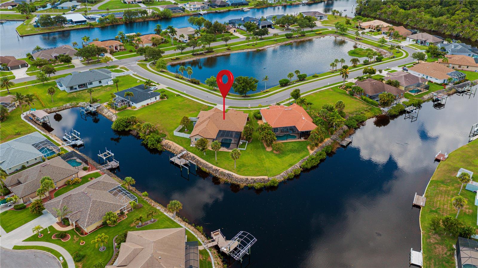 restricted community of Duck Key in North Port. Thoughtfully transformed into a warm and inviting rustic farmhouse, this beautifully updated property blends timeless character with modern upgrades and peaceful waterfront living. This spacious home features 4 bedrooms, 3 bathrooms, a private office, formal living room, family room, dining room, cozy dinette, walk-in pantry, large laundry room, and an additional storage room—offering flexibility for families, remote work, or entertaining guests. At the heart of the home is a fully upgraded custom farmhouse kitchen featuring stunning exotic granite countertops, a massive one-level island with cabinet storage on both sides, a beautiful copper farmhouse sink, and black and stainless appliances—creating a warm, functional space designed for gathering and everyday living. The primary bathroom is truly one of a kind, showcasing slate flooring and a slate walk-in shower, custom cabinetry with copper inlays, and a full-size copper utility sink—perfect for grooming pets or handling farmhouse-style tasks with ease. Nearly every major component of the home has been updated, including: New roof 2023, New AC system 2023. Gutters, fascia, and soffit in 2023. Impact windows 2022 & 2023, Newly refinished pool surface Updated pool deck pool cage enclosure in 2023. Tankless water heater. Dock with recently installed decking. Step outside and enjoy your private backyard retreat along the Myakkahatchee River, perfect for relaxing, wildlife watching, kayaking, or simply enjoying the peaceful Florida setting. Out front, a scenic pond creates a welcoming first impression and adds to the tranquil atmosphere. Additional highlights include: 3-car garage Side fenced yard for pets Beautiful rustic farmhouse finishes throughout Low HOA fees of just $700 per year Located in one of North Port’s best-kept secret neighborhoods Interior storage room Irrigation System On Well City Water and City Sewer This property offers the rare combination of privacy. Boating access & Gulf access  to Gulf of America via the Big Slough, Myakka River and Charlotte Harbor takeing you to a fishermans paradise and world class beaches. this home comes with rare to find  extensive upgrades, and farmhouse craftsmanship—all within easy reach of shopping, dining, and Gulf Coast beaches. A truly special home that must be seen to be appreciated.