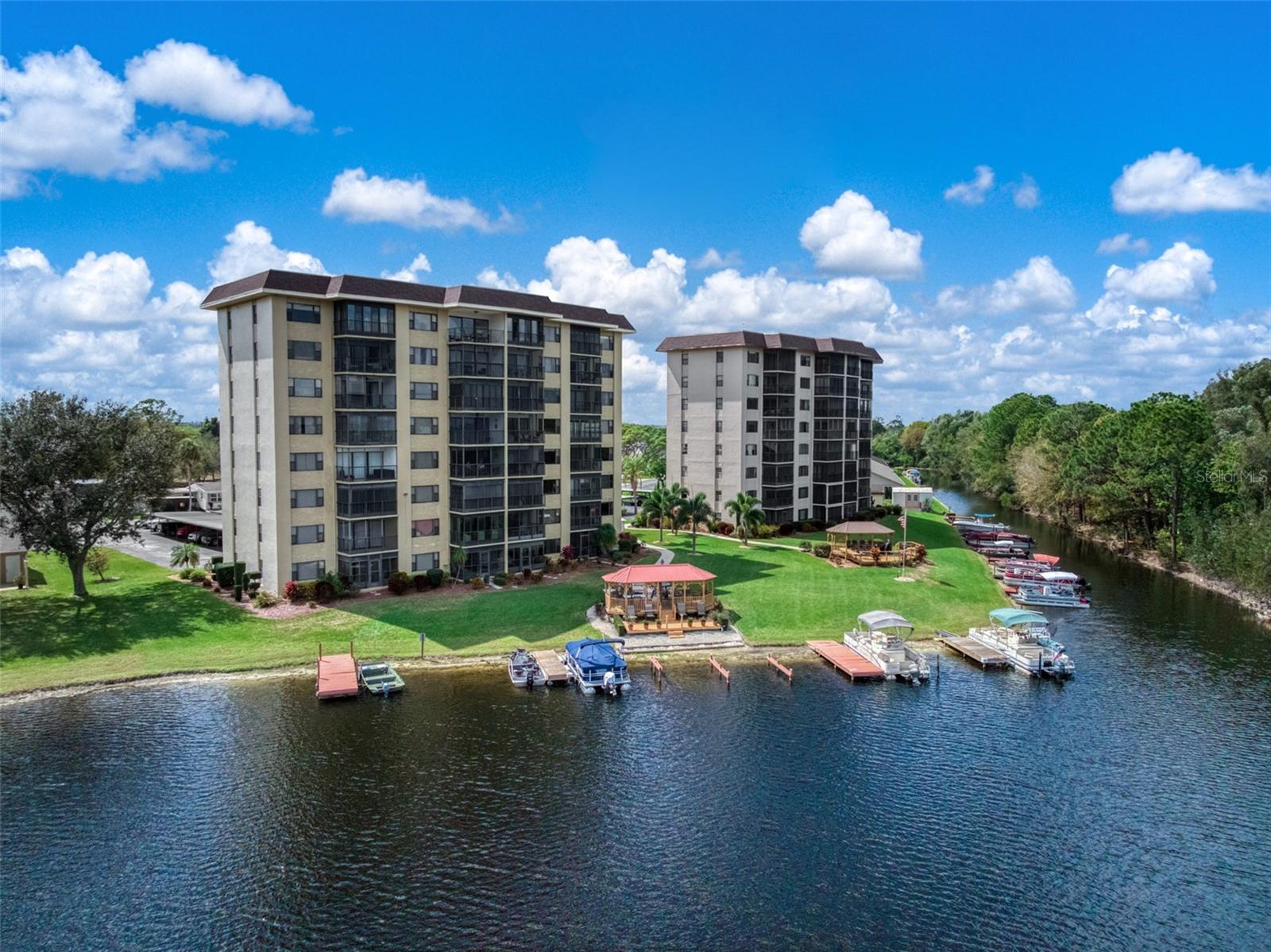 Wake up to beautiful views of 517-acre Lake Grassy from this inviting 2nd-floor waterfront condo in Lakeshore Tower One. This residence offers something buyers often look for but rarely find - peaceful water views, thoughtful updates, and a setting that instantly feels calm and welcoming. Filled with natural light, the comfortable living and dining areas create a bright and inviting atmosphere from the moment you step inside. The home features luxury vinyl plank flooring, fresh interior paint, updated electrical outlets, stylish fixtures, updated ceiling fans, efficient Whirlpool appliances, and a newer HVAC system with a digital thermostat for year-round comfort. Additionally, a credit toward a stove upgrade is also being offered. Both bathrooms have seen updates, including a renovated guest bath featuring porcelain tile flooring and a granite vanity countertop, along with a cultured marble shower and several ADA-friendly features designed for added accessibility. The enclosed Florida room extends the living space and is the perfect place to enjoy your morning coffee or tea, relax with a book, or unwind while taking in the breathtaking lake views. Residents enjoy a true Florida lifestyle with amenities including a spacious gazebo, sun deck, BBQ gas grill, on-site boat slips, beautifully maintained grounds, elevator access, shared laundry rooms, secure storage, and covered parking, while the HOA provides a low-maintenance living experience with many essentials included, such as water utility. Located just minutes from the charm, murals, shops, dining, and local attractions that make Lake Placid so special, this condo offers the perfect blend of comfort, convenience, and lakeside living. Whether you're searching for a year-round home, a winter getaway, or an easy lakeside retreat, this condo offers comfort, updates, and value all in one. Schedule your private showing today and come experience it for yourself.