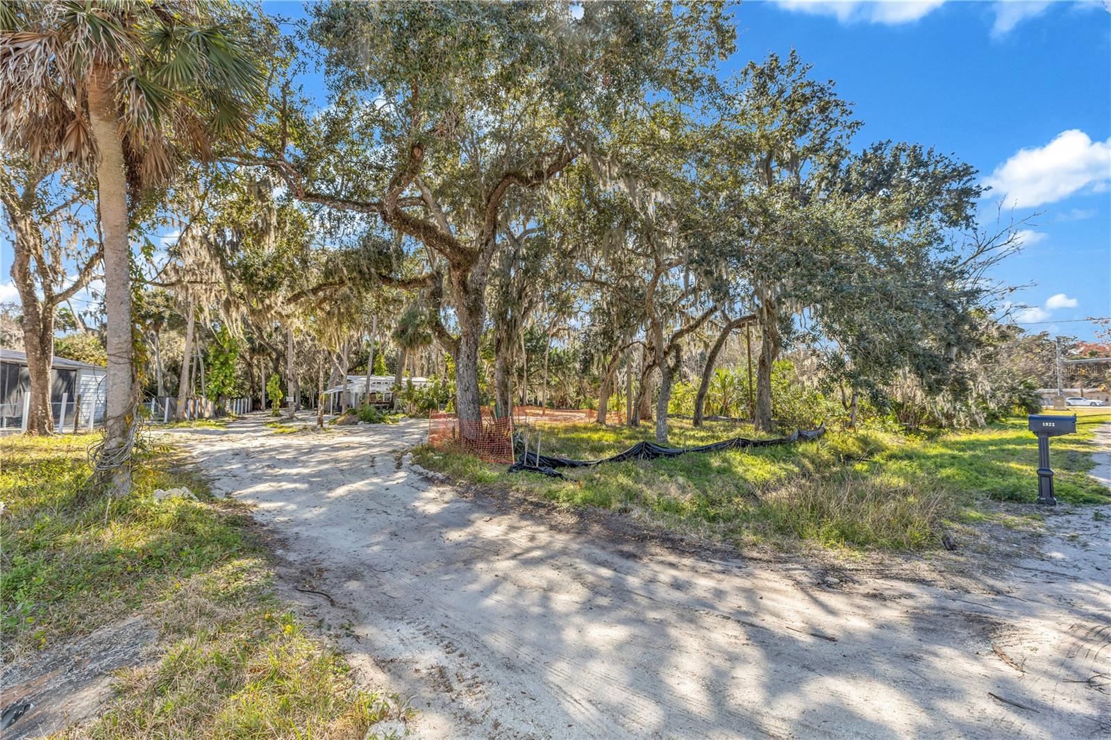 Partially cleared 1.29-acre lot offering a rare opportunity to build with confidence. Extensive due diligence has already been completed for the new owner, including a Wetland Delineation Report, elevation certificate, property survey, driveway plans, and house plans. The property features Florida charm with beautiful old oak trees, an existing greenhouse and workshop, plus over $4,000 in added soil to improve site preparation. Utilities are already in place with a water meter and electric, as there was a prior home on the property—impact fees may be reduced (buyer to verify). Located in a prime area with ample space to build your dream home. Endless possibilities on this spacious parcel.