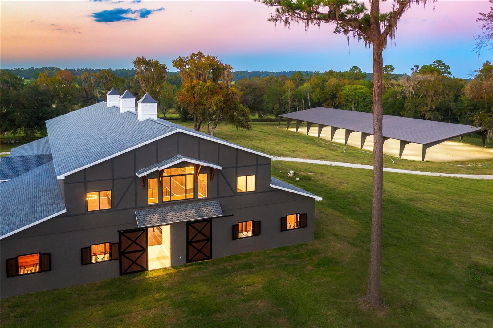 Victory Avenue is a truly exceptional 64+ acre horse farm located on the famous 225A! Just 10 minutes from WEC, the property sits right in the middle of what many consider to be the most highly desired horse country in all of Marion county. 
With magnificent rolling hill views and a live oak canopy lined driveway, this farm has everything an equine enthusiast could want. 
Including a brand new beautiful 5,180 sq ft 10-stall horse barn just recently built in 2022, a 2nd 10,000+ sq ft 18-stall horse barn that was just completed in 2023. Additionally, we have a brand new 120x250 ft irrigated covered riding arena finished with the industry leading GGT footing expert, Longwood.  The main residence is a beautiful 4,400 sq ft 5 bed/ 4 bath home, completely renovated, all new fixtures and appliances, 2 person sauna and more. 
Whether you are looking for your own private equine retreat or perhaps venturing into your own horse business, this property comes with an county approved site plan for an additional 2 guest cottages or maybe that dream home that you've been waiting to find just the perfect piece of land to build it on, this property is what you've been looking for!