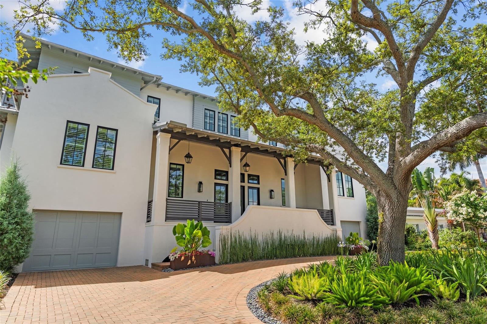 Great West Indies home with a full first-level garage featuring: gas generator, 2 gas tankless water heaters,
gas pool heater, scullery kitchen with a full Wolf/Sub-Zero appliance suite, and porcelain counters in the
kitchen and master…Gas generator, 2 gas tankless water heaters, gas pool heater, scullery kitchen with full
Wolf/Sub-Zero appliance suite, porcelain counters in kitchen and master bath, Kohler sinks and toilets, 10'8"
ceilings on 1st floor/10' on 2nd, marble floors in foyer and scullery, porcelain paver pool deck and porches,
all-metal roof, saltwater pool with Pebble Tec, elevator, epoxy garage floors, bonus room in garage prewired
for AC, 3 AC systems, Windsor windows and doors, clay driveway pavers, Coplay Coachman Series garage
door, all closets built out with custom cabinetry-grade master closets, 220V EV charging plug, putting green,
2,834 sq ft garage interior, push-button switches with brass cover plates, wine cooler in den.