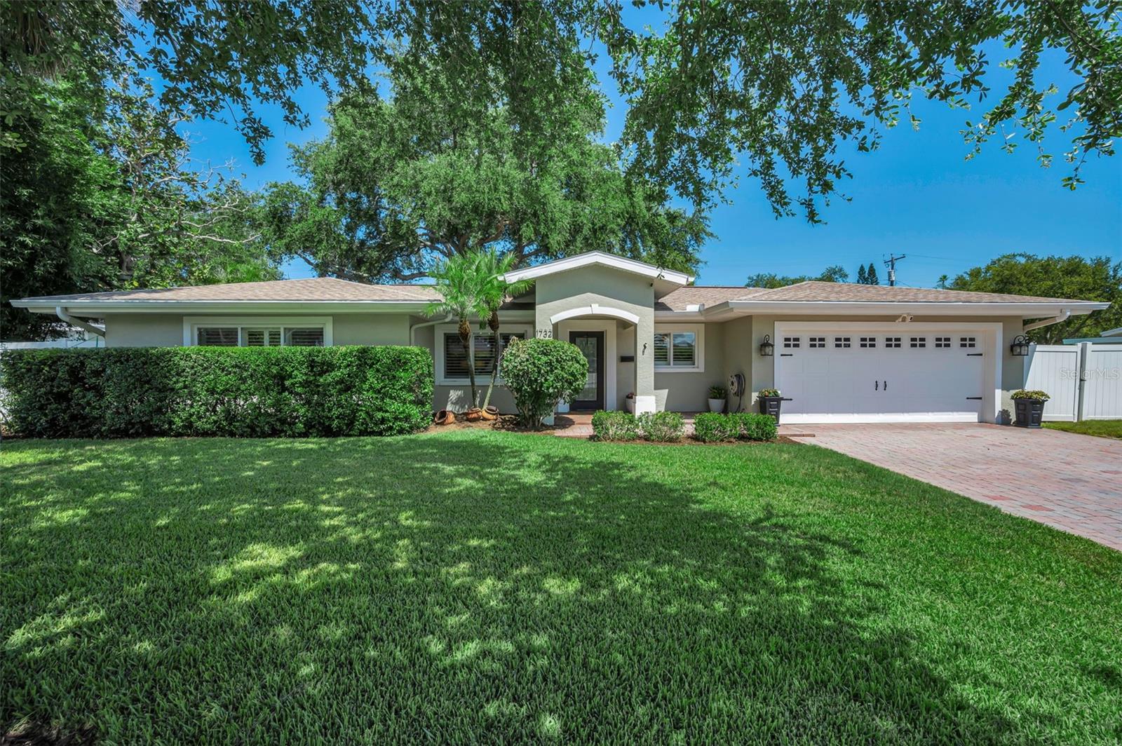 Experience refined living at 1732 Golf View Drive in the coveted town of Bellair where timeless comfort meets an exceptional location – close to the area’s most beautiful beaches and amenities but nestled away from traffic. Designed with an inviting open floor plan, this home has been beautifully updated to allow you to just move in and relax. There is a gracious sense of space from the moment you enter highlighted by seamless luxury vinyl plank flooring throughout the home in a soft neutral tone along with plantation shutters, premium 8-inch baseboards and large rooms that create an effortless flow for both elegant entertaining and relaxed everyday living. The living room features a coved ceiling and measures 21 ft. opening to the perfect dining room overlooking the generous back yard. The 23 ft. family room offers additional expansive space with 10 ft. ceilings and 10 large windows grace the entire back of the home for streaming natural light and private views. The kitchen is well-equipped with stainless steel appliances and granite countertops and features a breakfast bar opening to the living areas. With 10-ft. ceilings, you’ll feel pampered in the 17’ x 14’ primary bedroom retreat with spacious walk-in closet, updated bath with double vanities and large shower with gorgeous tile and dual shower fixtures. The split floor plan also provides privacy and secondary bedrooms with one oversized at 15’ x 10’ – perfect for a home office or additional space.  Another retreat is the truly private backyard complete with mature landscaping and sprawling pavered lanai with plenty of room for dining, lounging, grilling and entertaining all within a private setting complete with vinyl fencing. The spacious yard even has ample room to add a pool if you so desire. Matching pavers also highlight the front walk way and drive leading into the full 2-car garage with Gorilla epoxy floor. A large laundry room is featured off the kitchen and for extra storage, the owner installed a Premier Pro Plus Tuff Shed in 2023 with higher side walls and galvanized steel floor to help prevent deterioration and rust. It is rated up to 155 mph winds and located on the side yard with a large gate for easy access. This residence is situated in the preferred Zone X, where flood insurance is typically not required by lenders. Home updates include new roof, new A/C unit and new water heater all installed in 2020 along with new impact glass slider in 2024 and all new ductwork in 2026. Natural gas connection is on the property and available for hook up.  Ideally positioned for those who value convenience and lifestyle, this residence affords privacy from neighbors and traffic while being close to beaches, shopping, dining, recreation and more. With its spacious interiors and desirable setting, 1732 Golf View Drive presents a wonderful opportunity to enjoy the best of luxury living in Belleair.