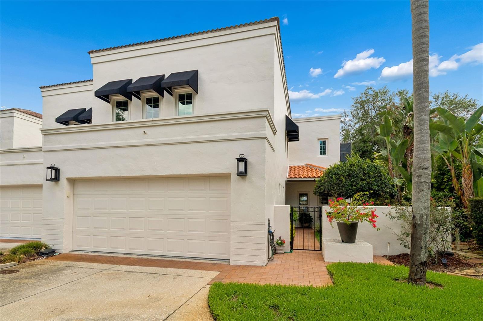Discover a rare blend of privacy, natural beauty, lush gardens, maintenance free-living, and convenience in this exceptional lakefront end-unit townhome in the exclusive gated community of Lake Ellen Landings. Tucked away at the end of a quiet, tree-lined street in the heart of Carrollwood, this beautifully updated 3-bedroom, 2.5-bath residence offers breathtaking water views, remarkable privacy, and the feel of a single-family home. A private garden entry leads into a light-filled interior with soaring ceilings, formal living and dining rooms, plantation shutters, custom drapes, and panoramic lake views. The beautifully appointed kitchen features stainless steel appliances, granite countertops,  and custom cabinetry, and opens to a spacious family room with a custom-built electric fireplace and dramatic wall-to-wall views of the lake. Just beyond, the Mediterranean-style screened lanai is a private saltwater pool and spa, creating a truly spectacular setting for relaxing or entertaining. Upstairs, the primary suite offers a private balcony overlooking the lake, dual vanities, a soaking tub, separate shower, and a walk-in closet. Recent upgrades include a new pool pump and gas heater. Complete with boat dock and water access, no flood insurance required, and a prime location just minutes from the airport, beaches, shopping, dining, and everything Tampa Bay has to offer, this is a rare opportunity to own one of Carrollwood’s most special homes.