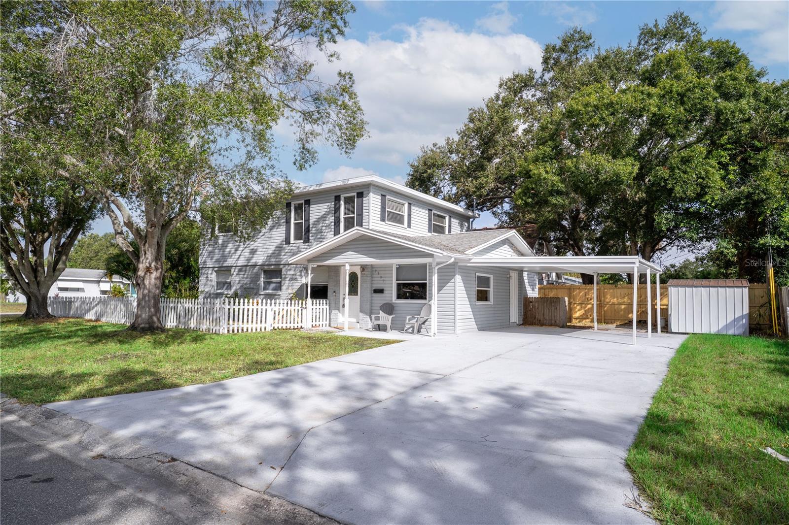 Completely updated and move-in ready, this 4-bedroom, 3-bath single-family home in St. Petersburg sits proudly on a corner lot and offers modern living at its best! The open-concept layout features LVP flooring throughout the common areas, a spacious dining room and kitchen with a peninsula, stone countertops, stainless steel appliances, a stunning backsplash, recessed lighting, and plenty of cabinet space. Enjoy multiple living areas, including a separate family room and an upstairs loft—perfect for entertaining or a home office. The primary suite includes a walk-in closet and en-suite bath, while the bedroom on the main floor offers a private entrance ideal for guests or multi-generational living. Outside, you'll find a fenced backyard, a two-car covered carport, and an additional storage shed. Located just minutes from the water (but in a non-flood zone!) and close to Walter Fuller Park, beaches, shopping, dining, and entertainment. Don’t miss your chance to call this beautiful home yours—schedule your showing today!