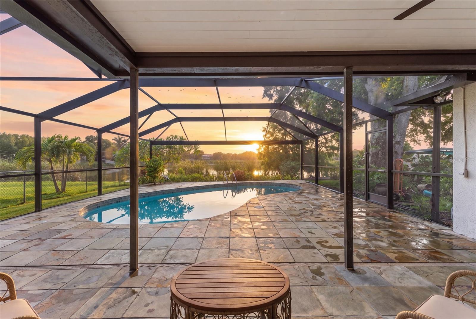 On the water in Largo. There's a rhythm to this one. Sunlight moves through open, flowing living spaces where every window opens onto Lake Allen — the water is always right there, in the kitchen, in the bedrooms, in that first cup of coffee. Step outside and your inground pool sits perched above the shoreline, so a swim comes with a lake view and the lake comes with a pool. And because this is a no gas motor lake, the water stays glassy and calm — just the soft kind of quiet you can actually feel.  This 3 Bedroom 2 Bathroom home is wrapped in lush, private greenery, framed by water on one side and a canopy of green on the other. Underneath it all: a brand-new roof — yes, the insurance conversation just got a whole lot easier. Kayak at sunrise, float the afternoon away, or simply watch the sky turn colors from your own stretch of Florida shoreline.  More to Come!